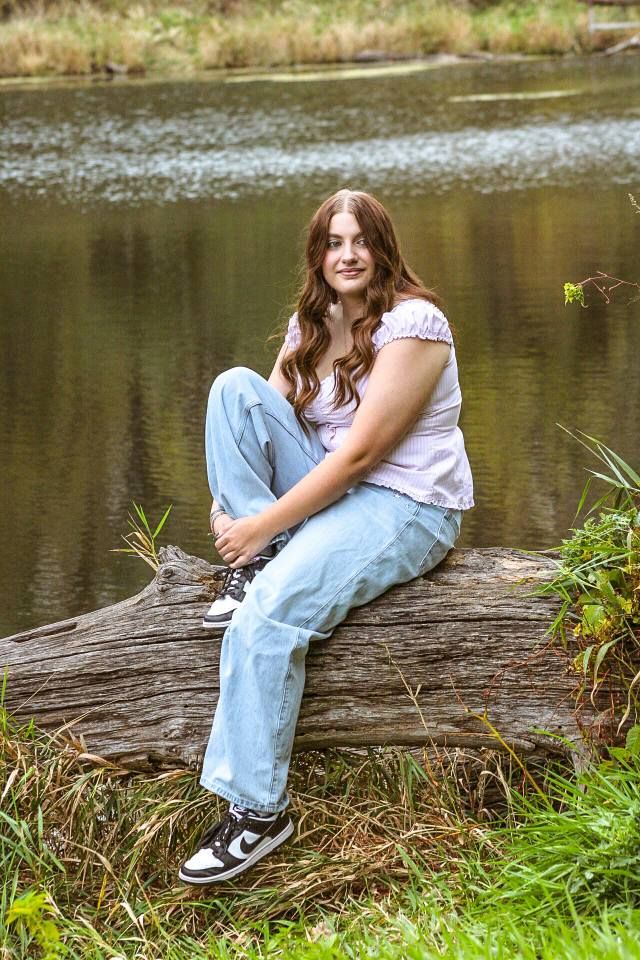 Senior portrait of female on log, Stone State Park, Sioux City, Iowa