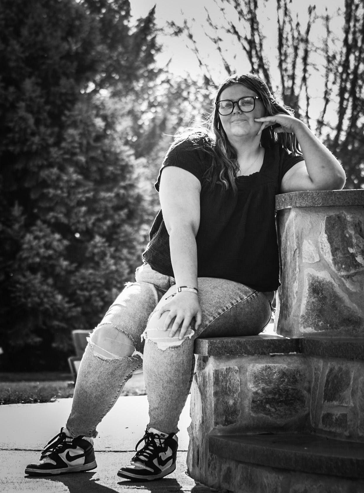 Senior portrait of female by religious statue, Trinity Heights, Sioux City, Iowa