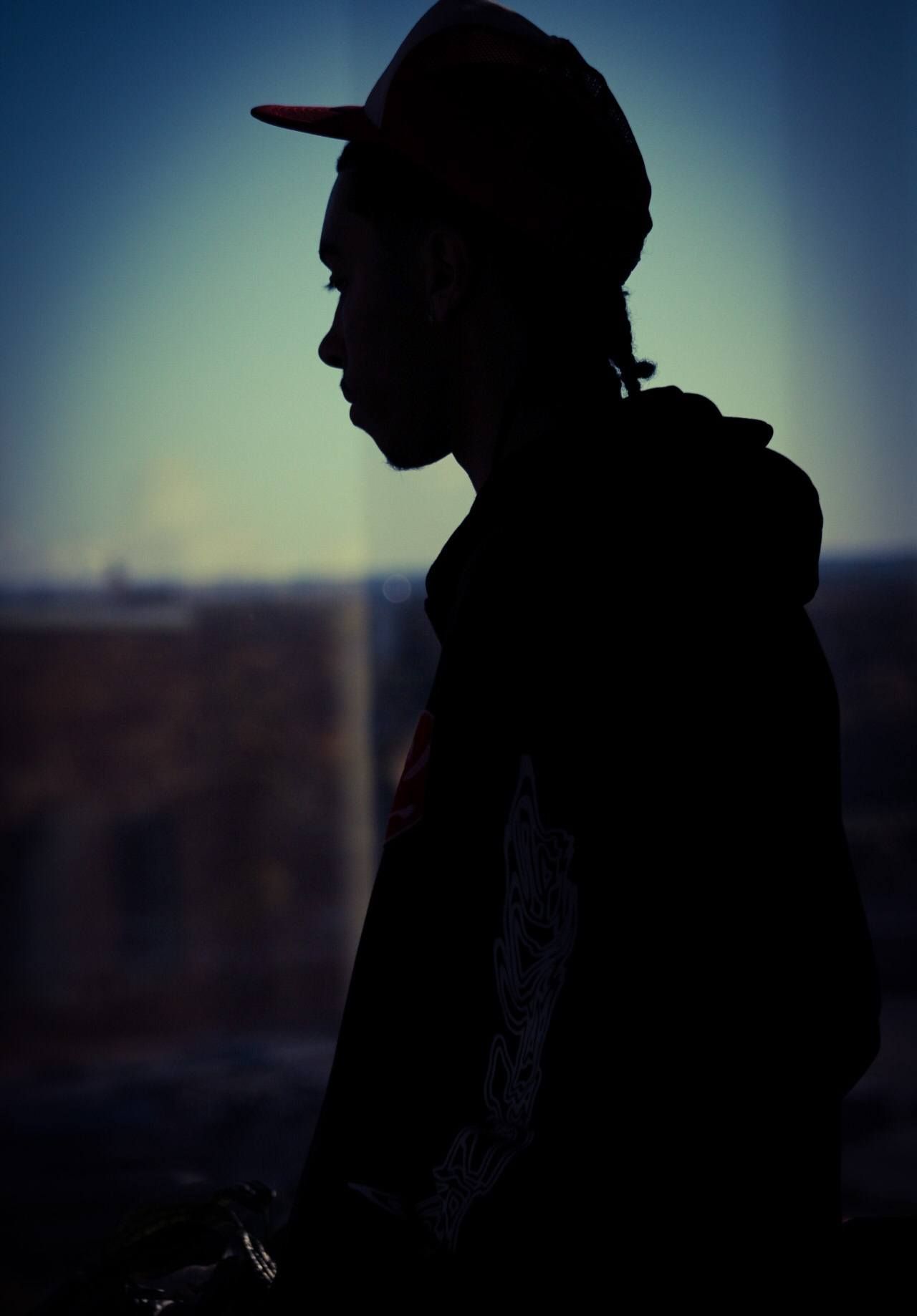 Senior portrait of male posing by window in downtown Sioux City, Iowa
