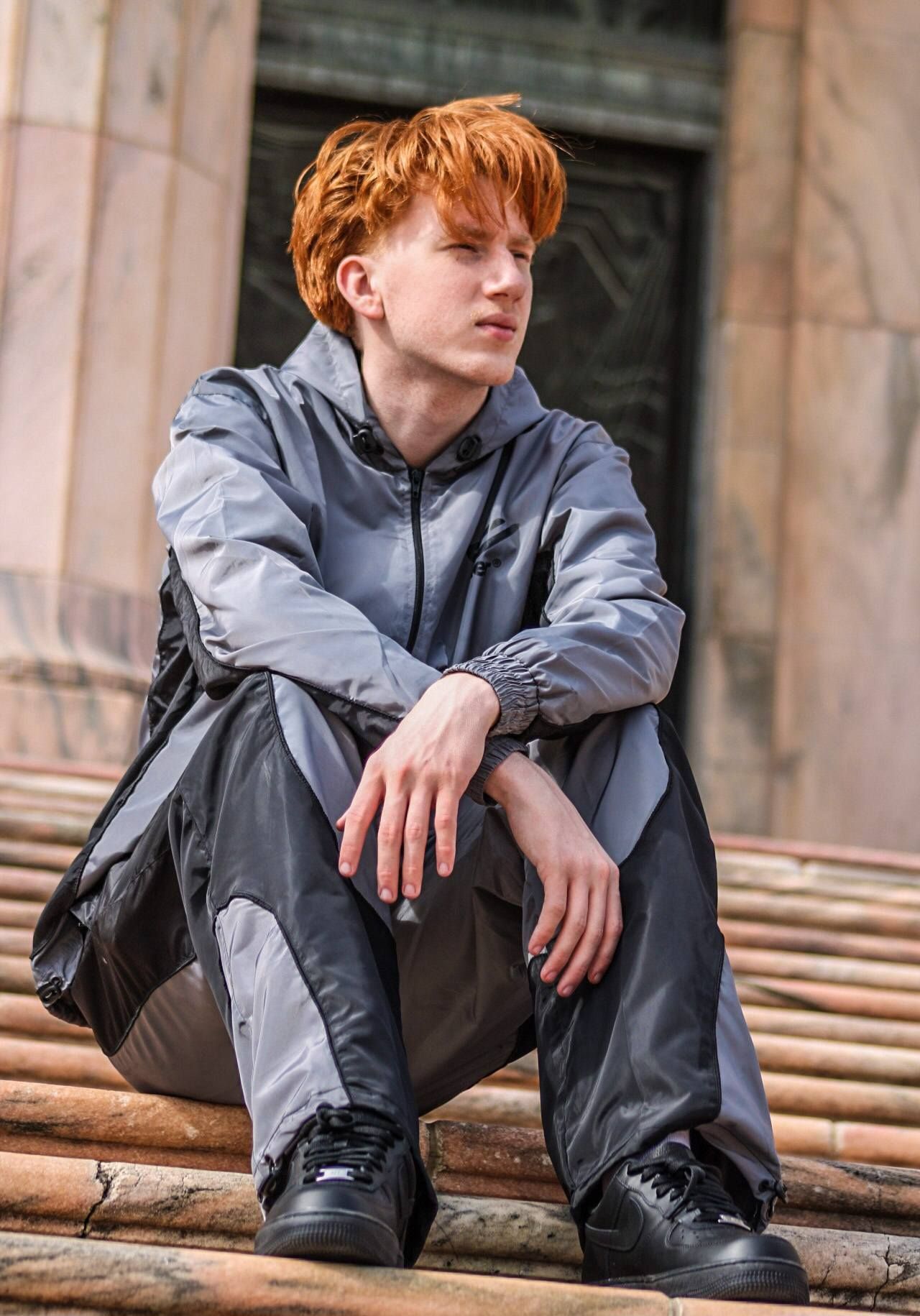 Senior portrait of male posing on marble steps at Joslyn Art Museum, Omaha, Nebraska