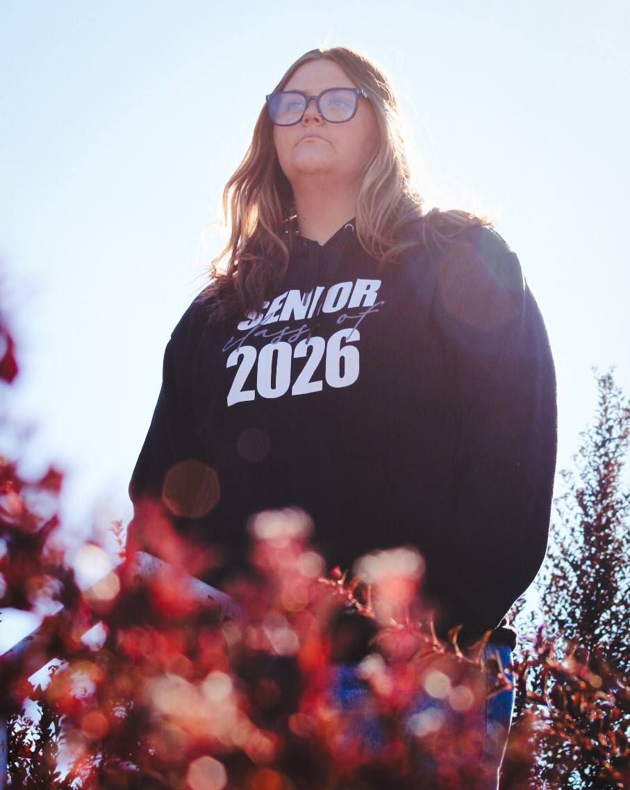 Senior portrait of female by bushes on steps, Grandview Park, Sioux City, Iowa