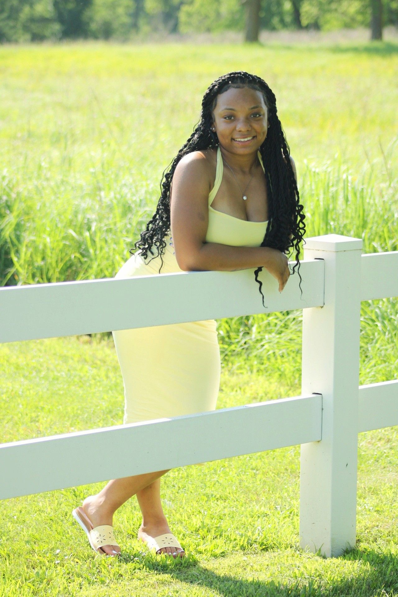 Senior portrait of female posing by wooden fence, Adams Homestead, North Sioux City, South Dakota