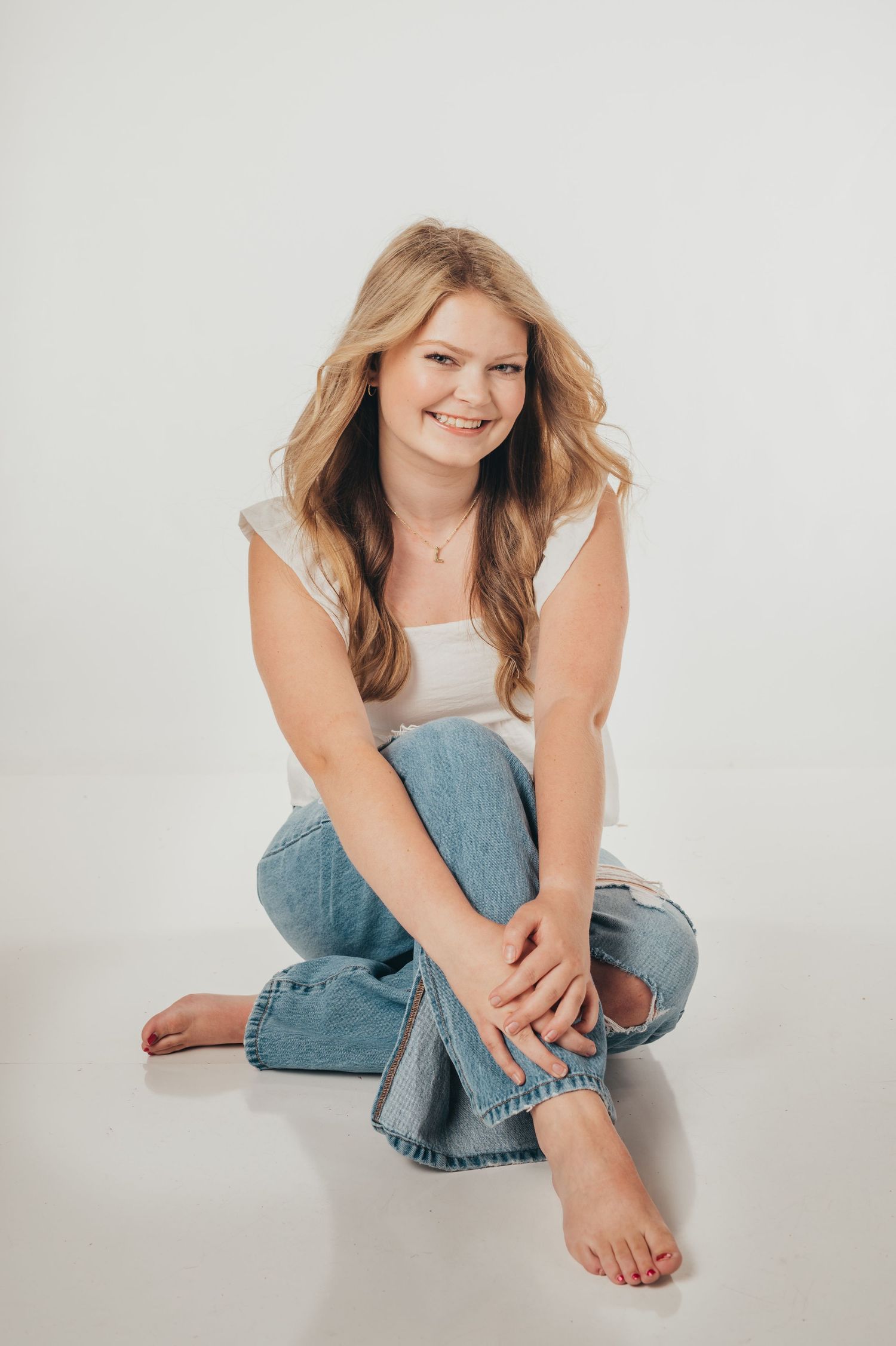 Studio portrait series on white background wearing casual denim outfit.