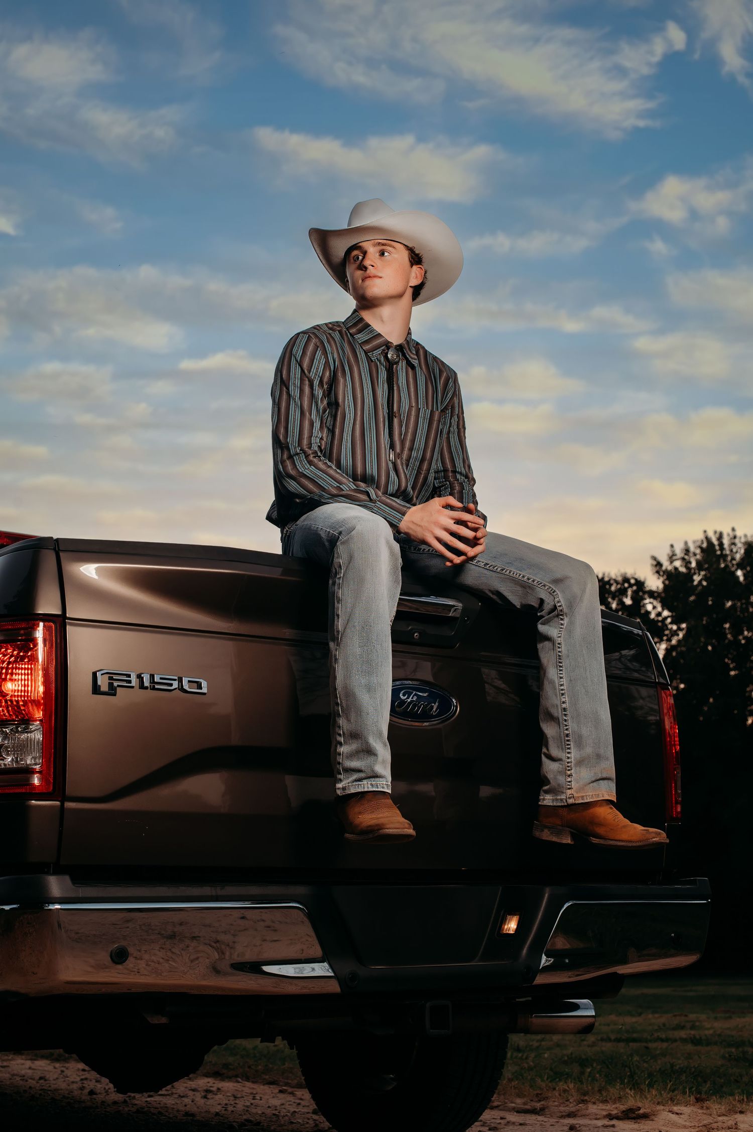 Evening portrait series with Ford F150 pickup truck and western attire.