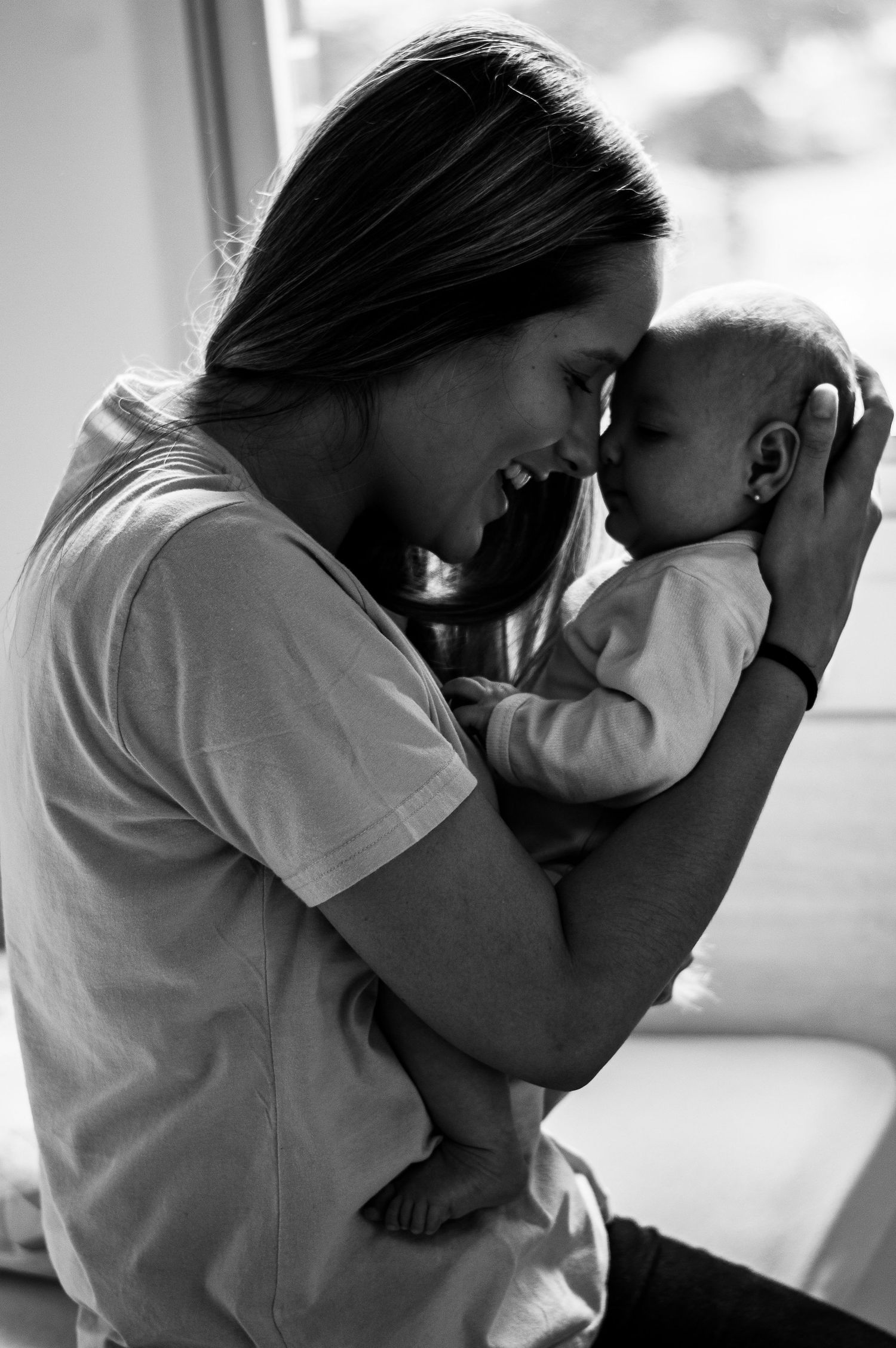 Black and white series of intimate moments between parent and child.