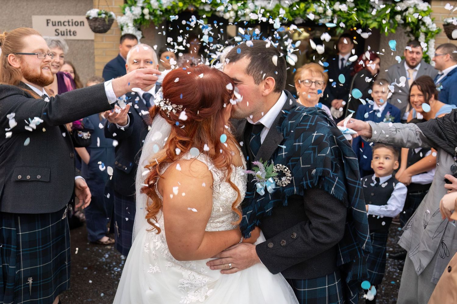 A romantic wedding sequence showing the couple celebrating with confetti and guests during an outdoor celebration.