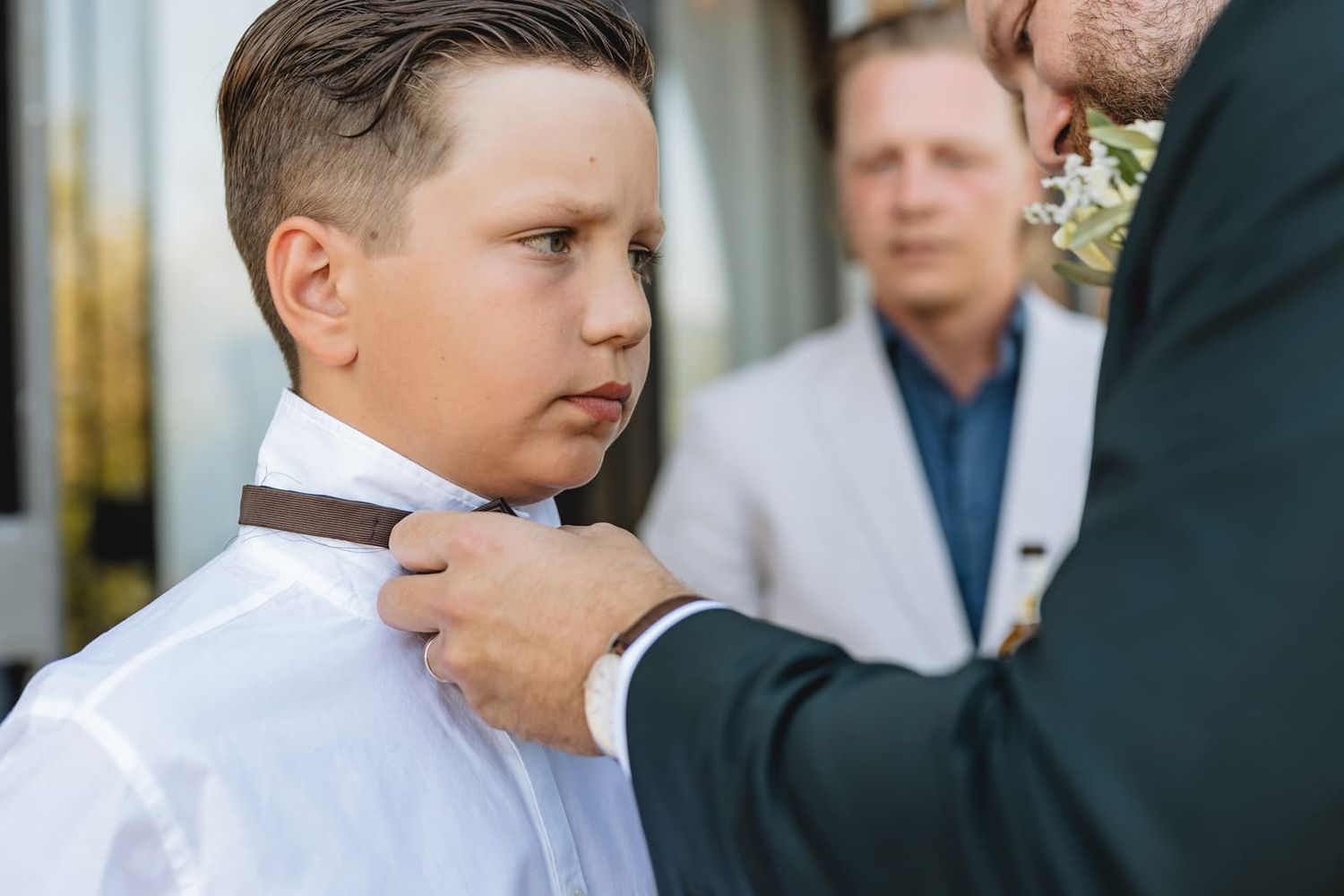A young guest gets help with his tie before the ceremony, Borgo San Faustino, Orvieto