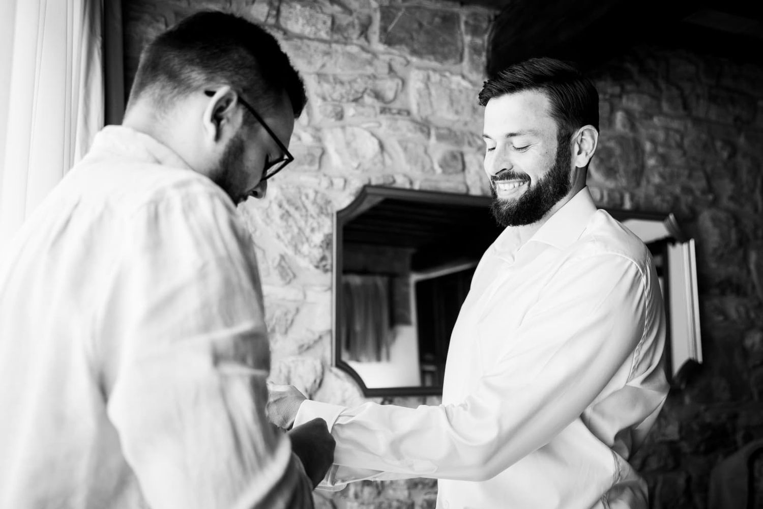 The groom getting ready with a friend in black and white, Villa Le Bolli elopement