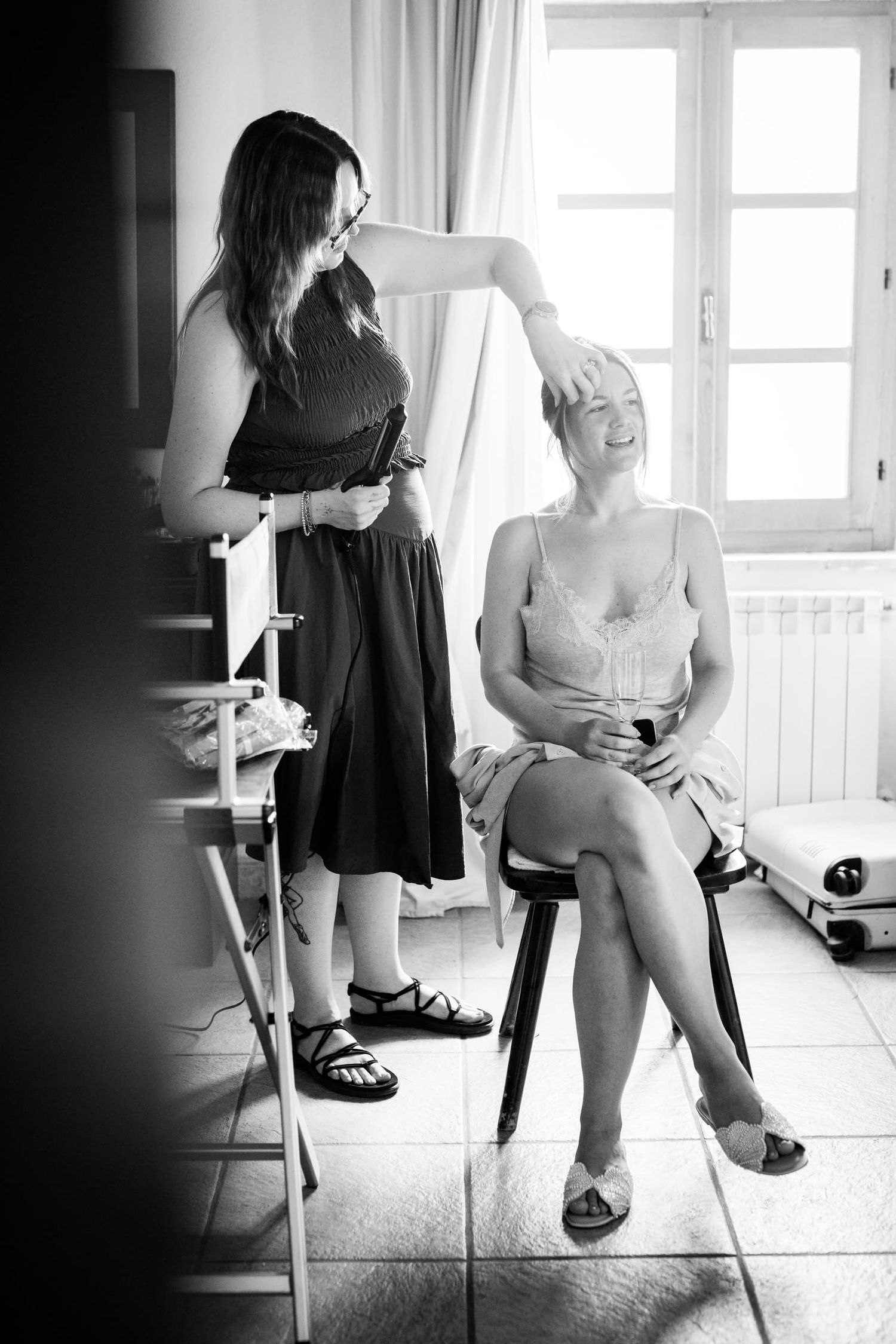 Getting ready with the hairstylist in a bright room at Villa Le Bolli, Tuscany