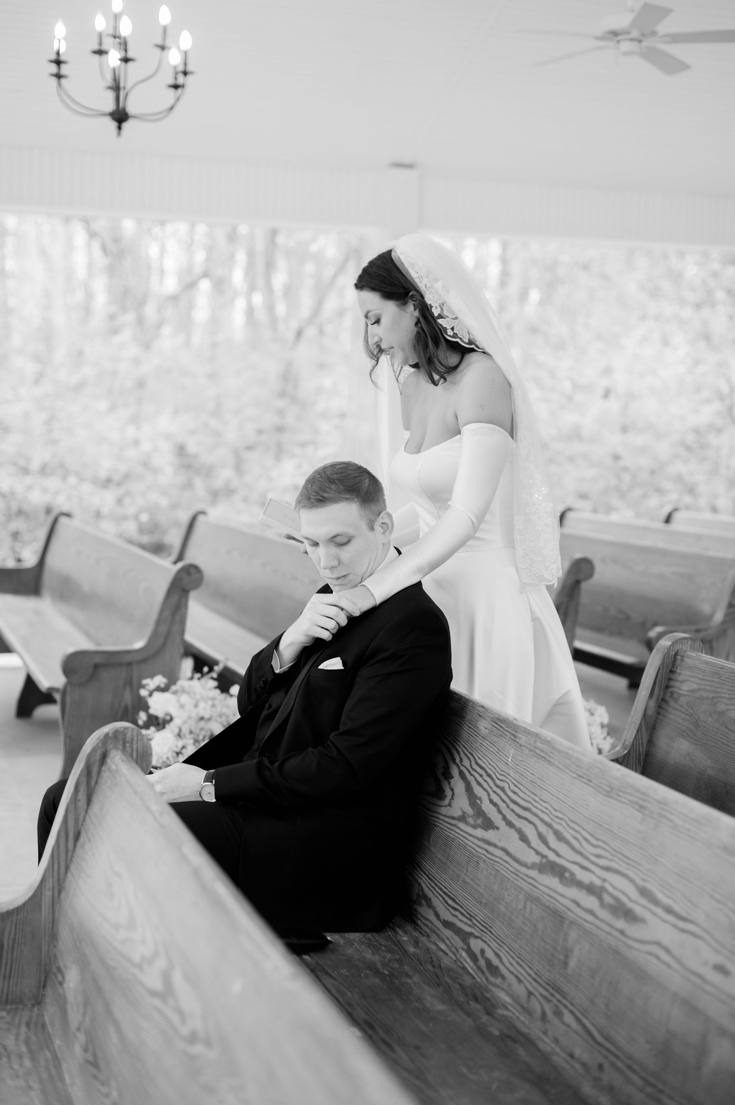 A series of intimate moments captured between a couple sitting on wooden church pews.