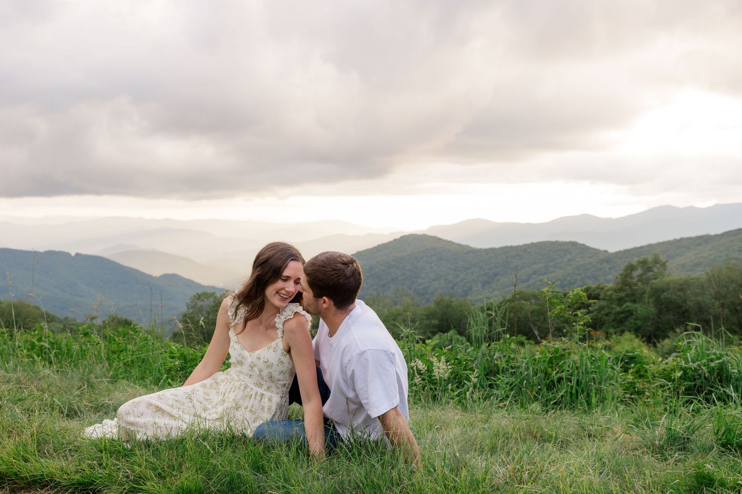 North Carolina engagement session. Mountain landscape with rolling hills and dramatic clouds at sunset.