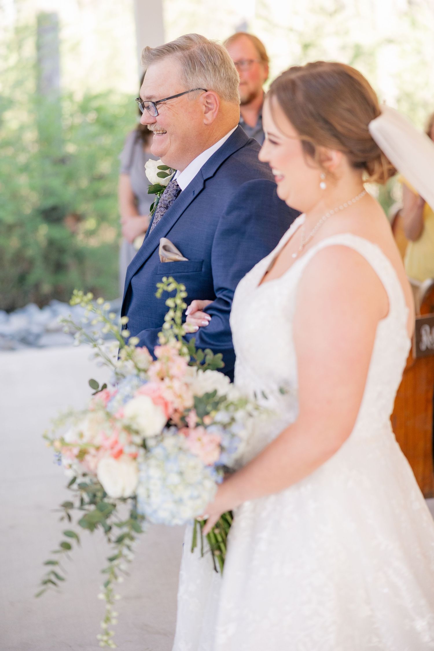 An emotional wedding ceremony takes place in a bright white chapel with wooden pews.