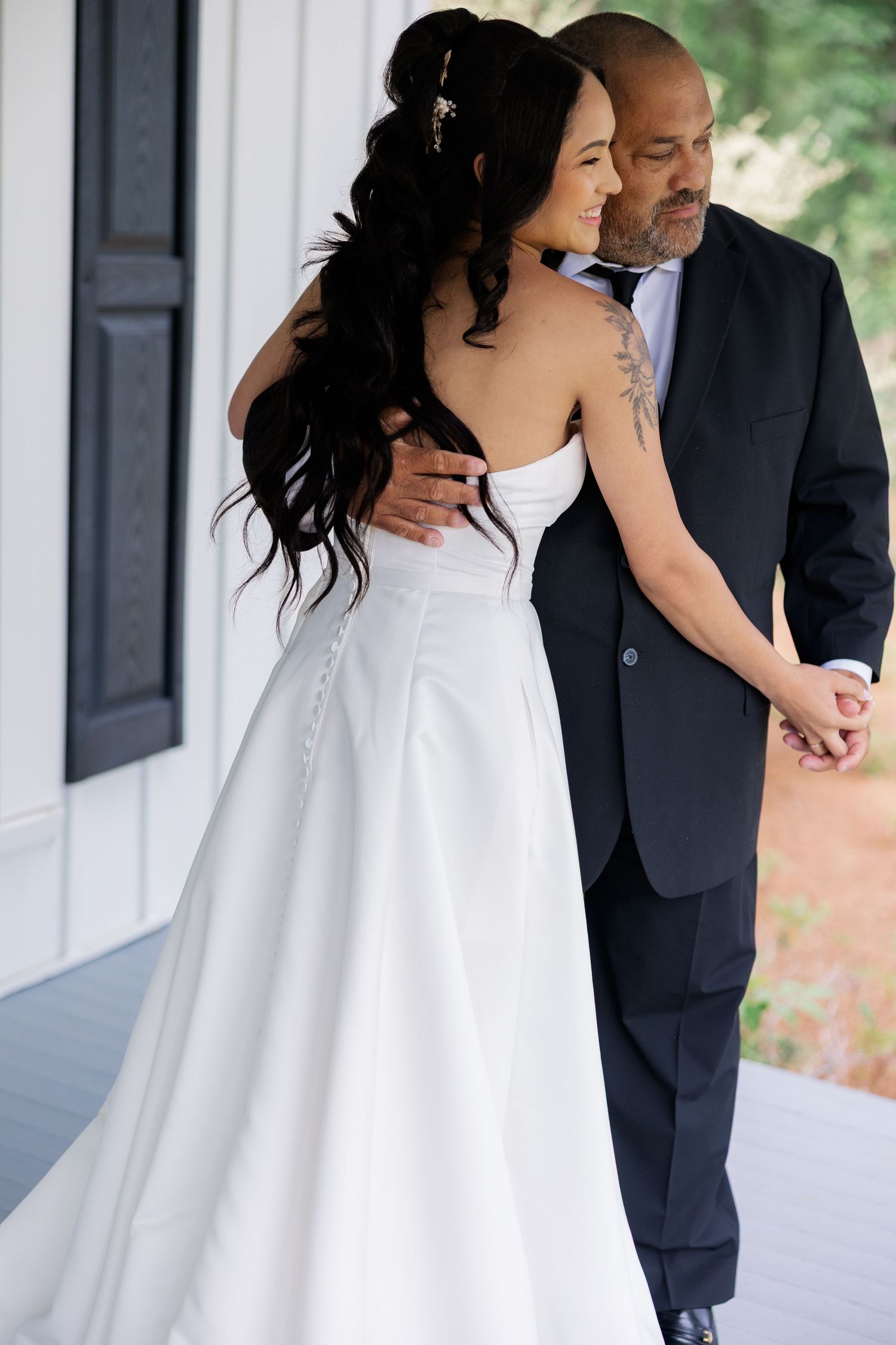 Beautiful bridal photography session featuring a flowing white gown against white chapel architecture.