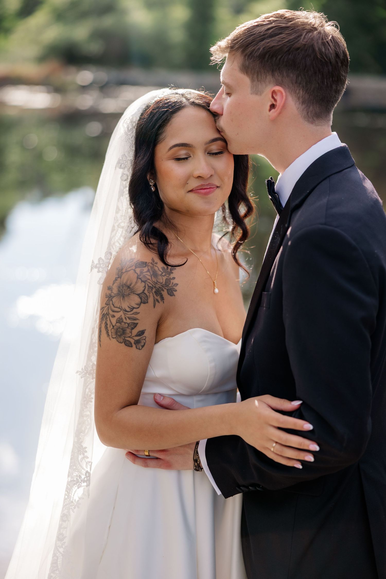 A tender romantic moment captured between newlyweds outdoors.