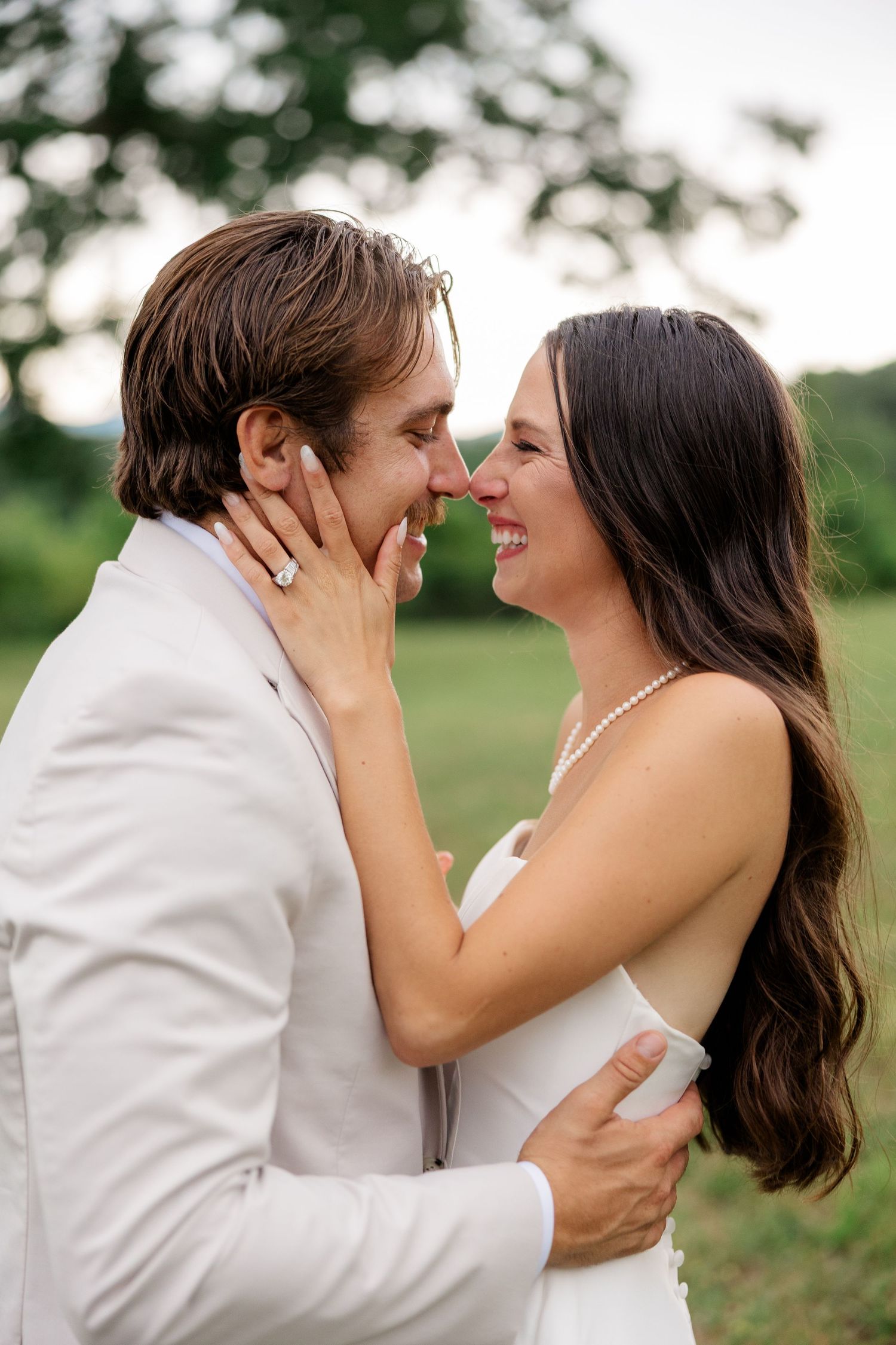 A romantic moment captured between newlyweds in an outdoor setting.