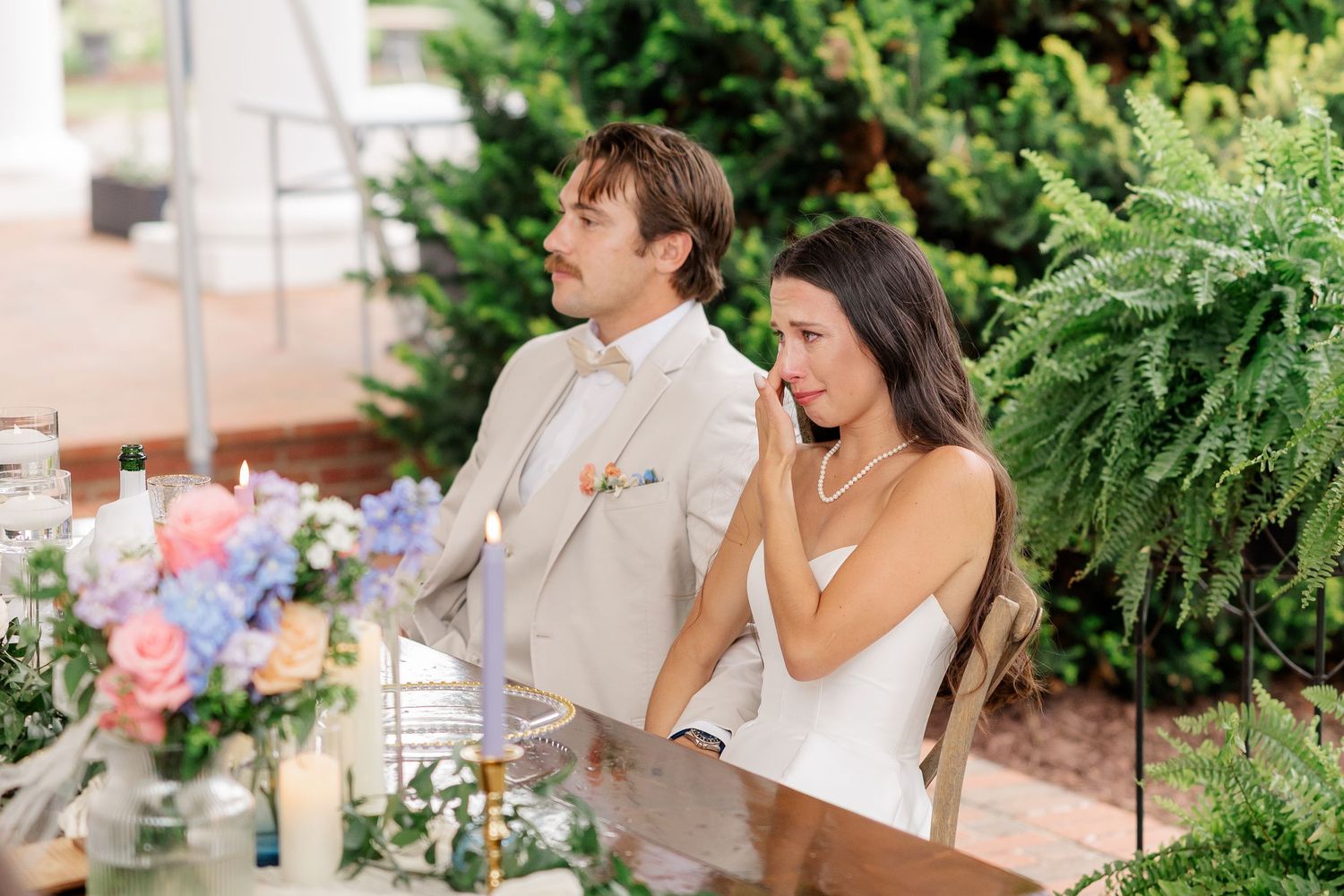Wedding celebration candid moments captured outdoors with greenery and festive decor.