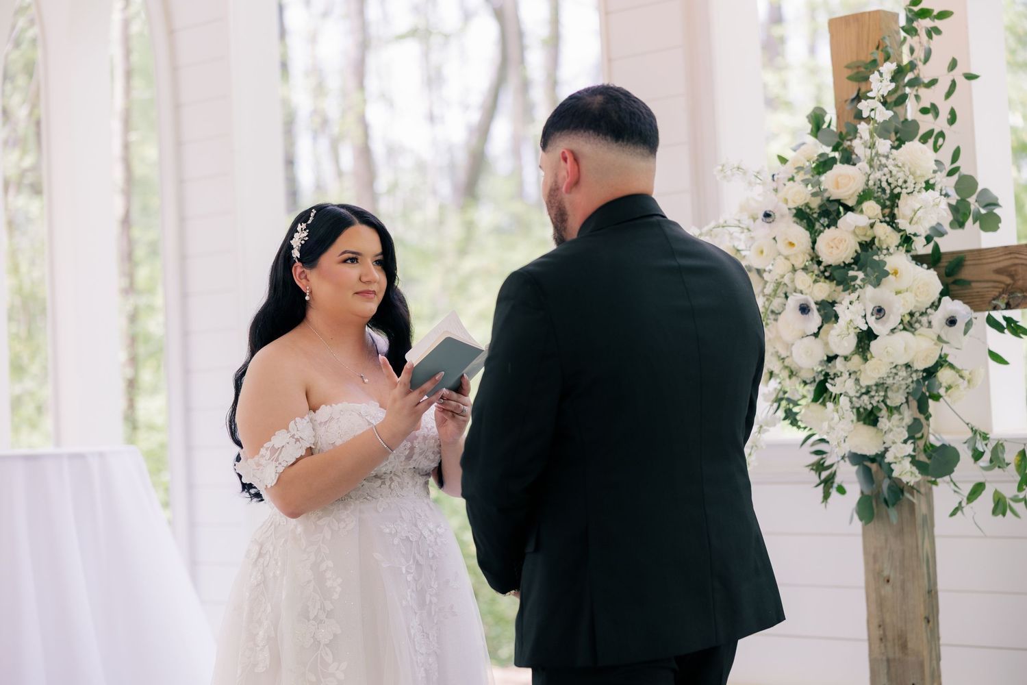 Couple in formal attire dancing together during an intimate indoor wedding reception.