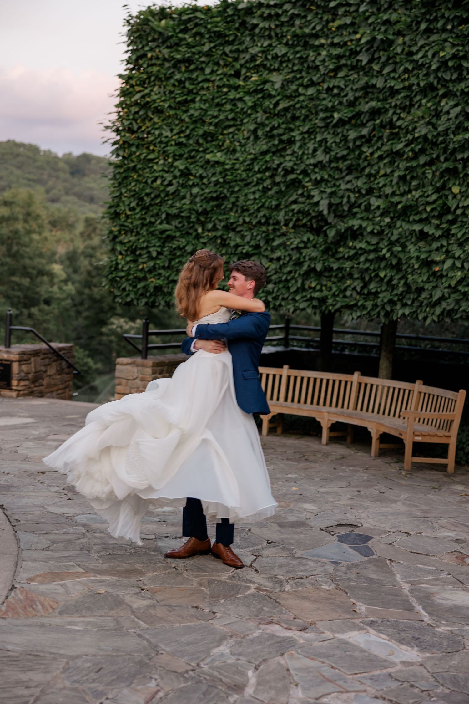 A romantic dance sequence on a stone patio with ivy-covered walls in the background.