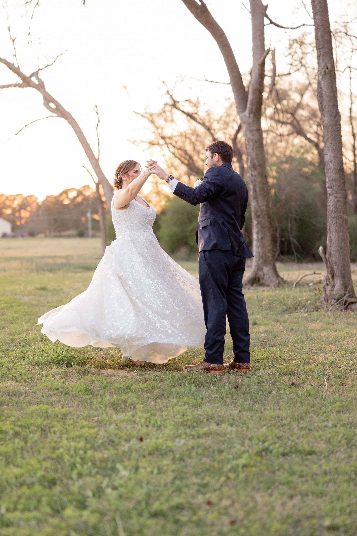 Romantic outdoor photo shoot among tall trees during golden hour.