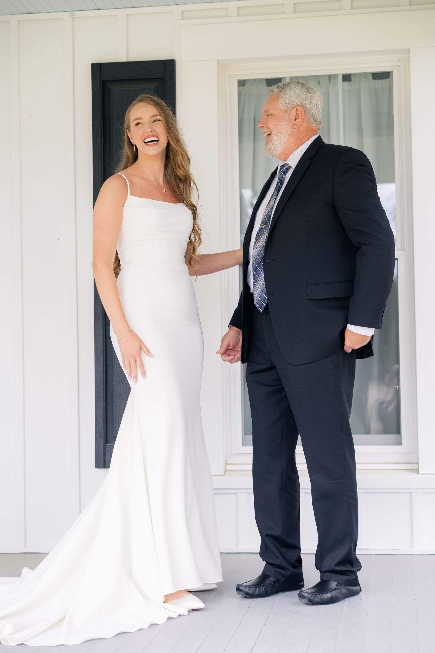 First look wedding photos on a white porch showing sweet moments between the couple.