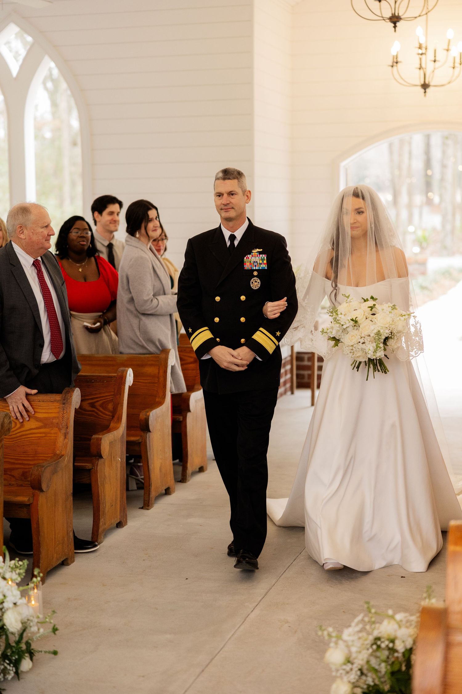 Wedding ceremony sequence showing bride and groom walking down church aisle with guests seated in wooden pews.