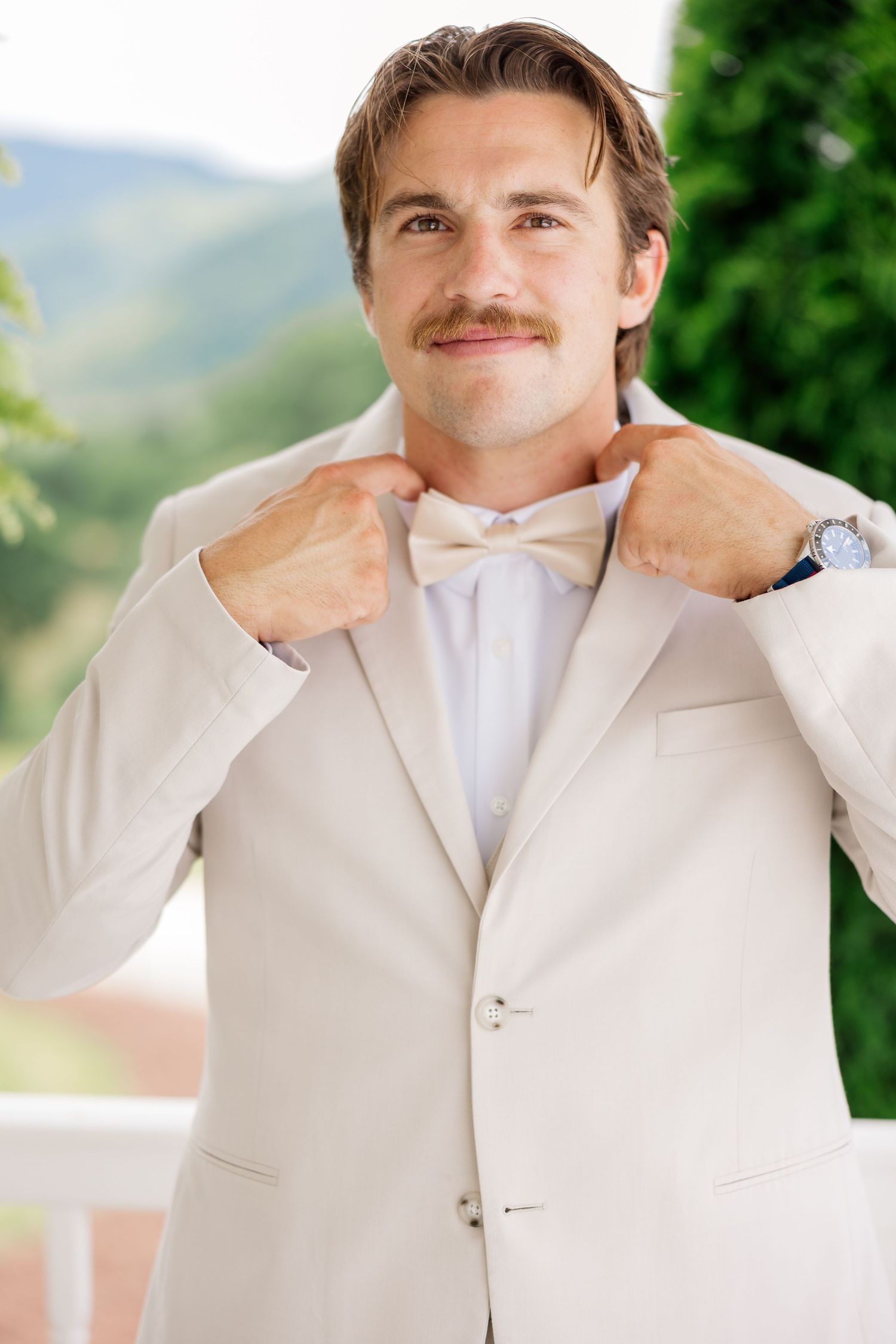 A series of photos showing a groom in a white suit reacting emotionally during a wedding moment.