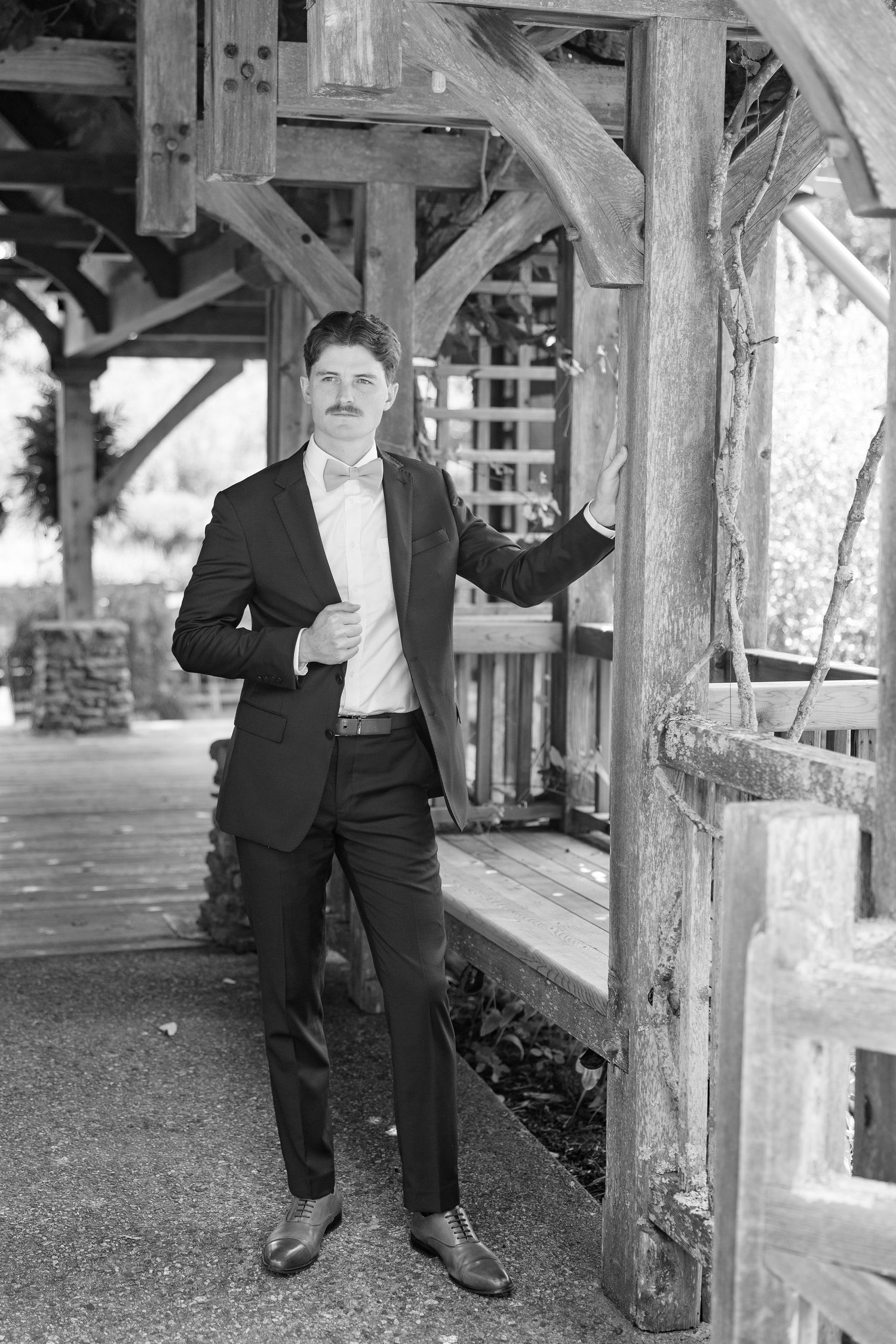 A series of black and white portraits taken under a rustic wooden structure.