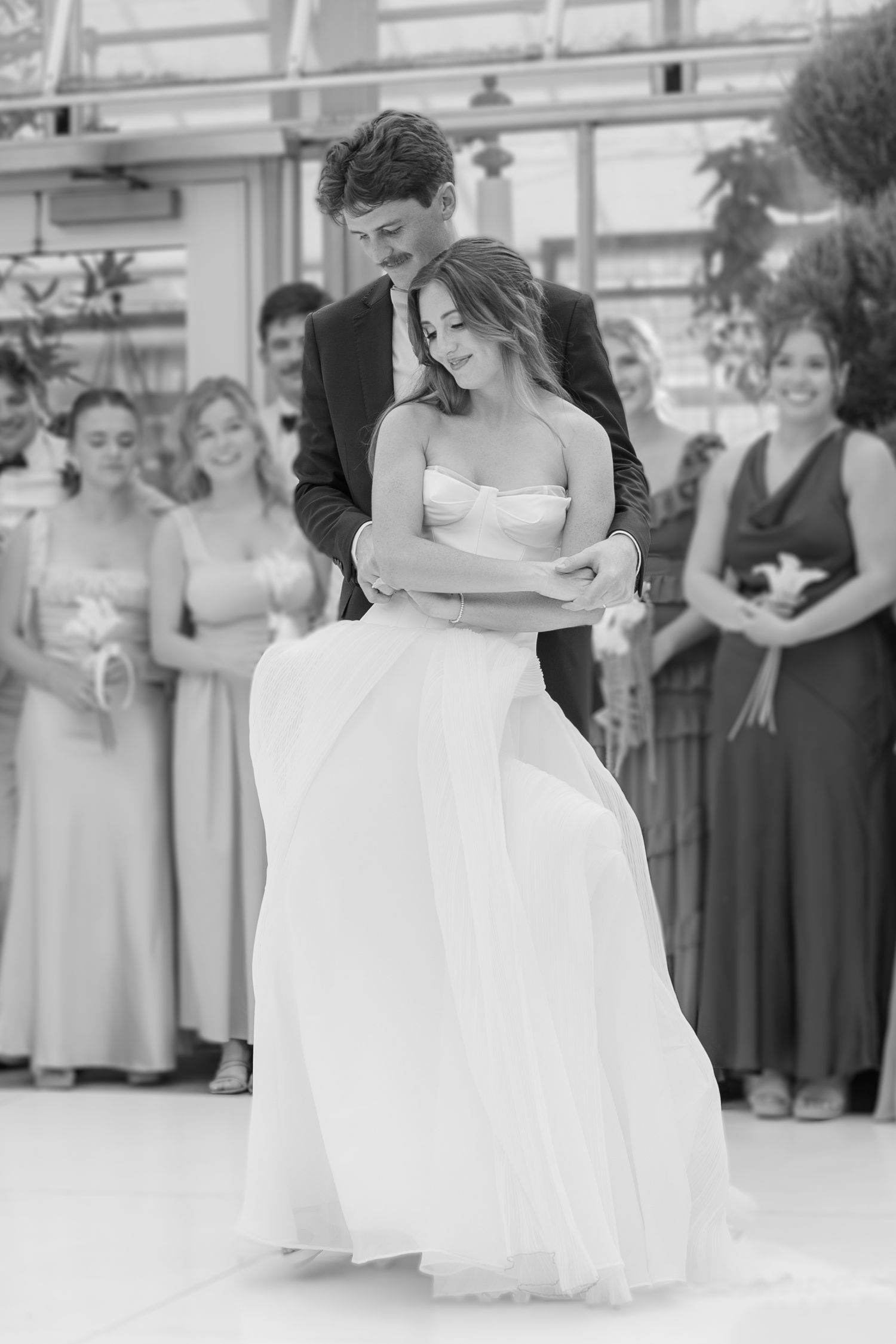 Romantic black and white photo of a couple sharing their first dance at a wedding reception.