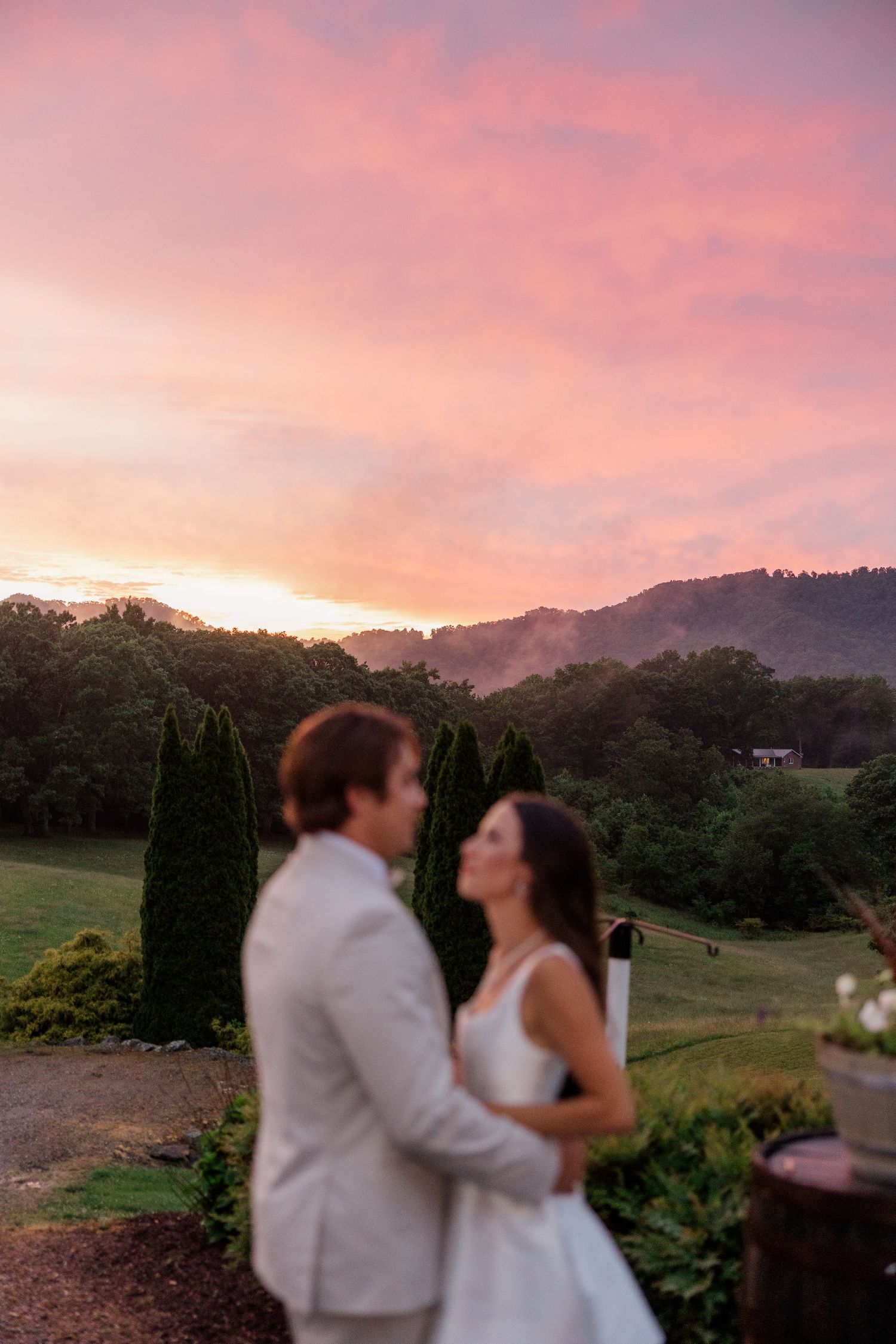 Romantic sunset view of mountains and landscape during an outdoor wedding celebration.