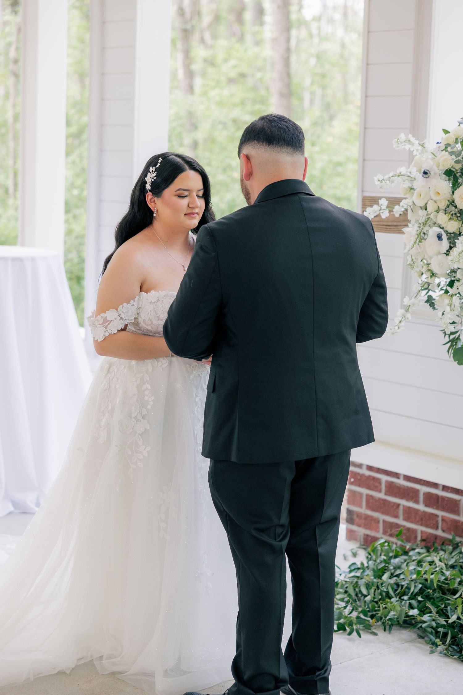 Emotional wedding first look sequence showing couple's genuine reactions on a covered porch.