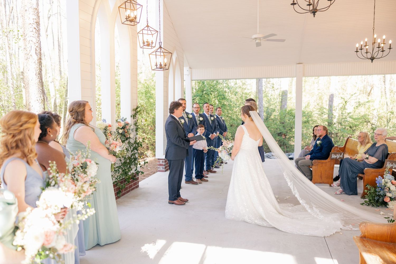 Modern chapel wedding ceremony space with white decor and natural lighting.