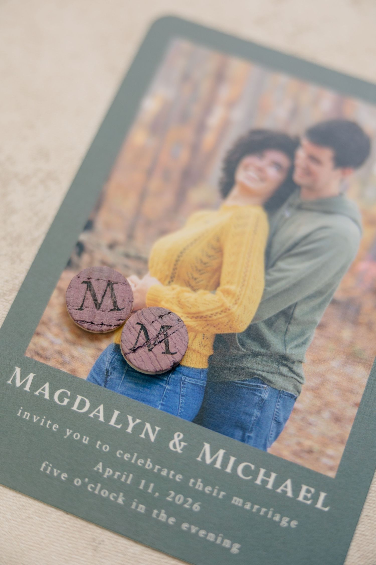 Wedding invitation for Magdalyn and Michael on April 11, 2026 with wooden monogram magnets.
