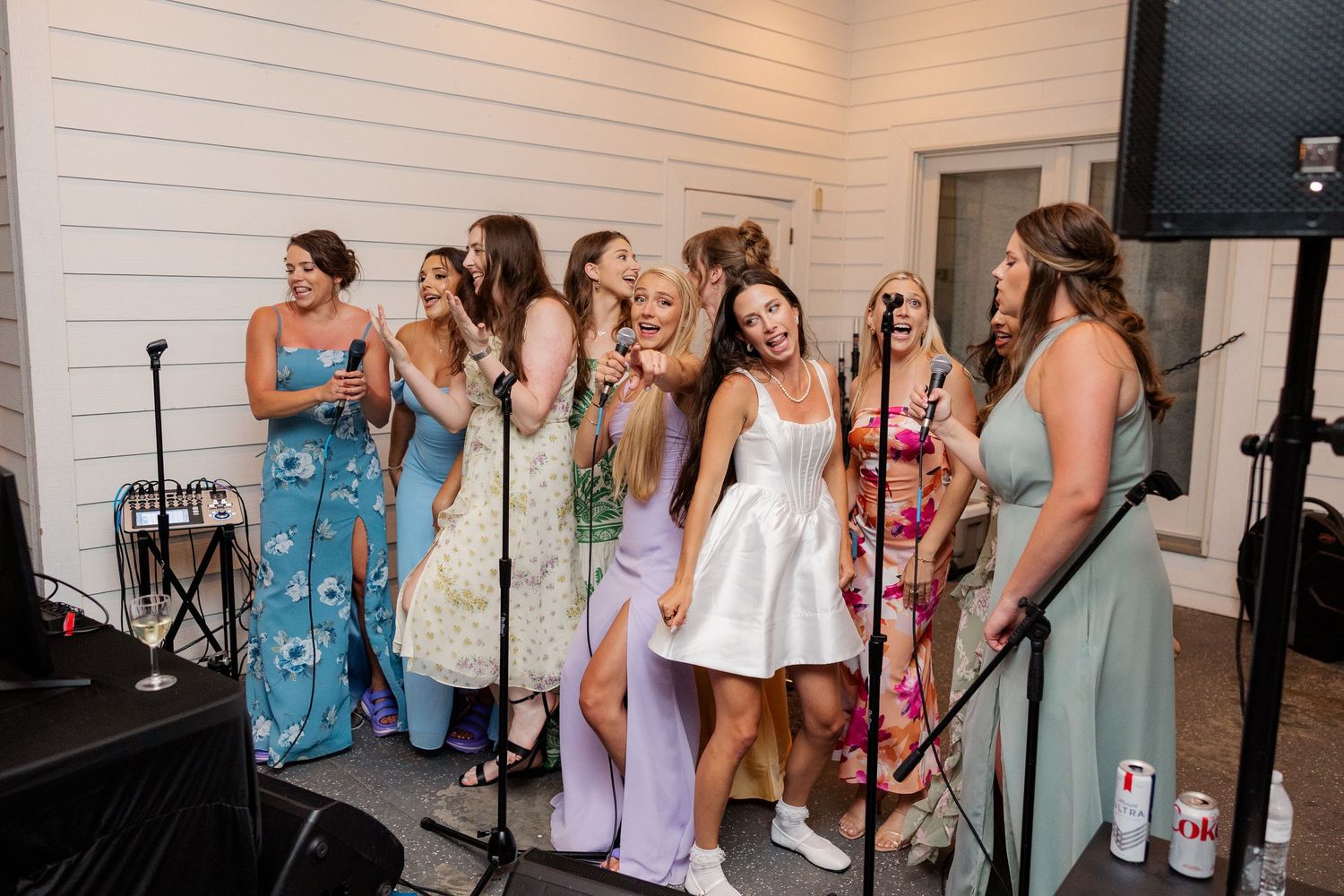 Wedding party members dance and celebrate together during the reception festivities.