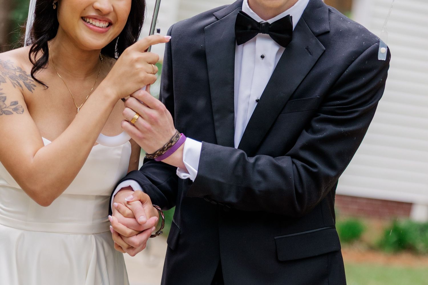 Newlyweds sharing joyful moment together in elegant wedding attire.