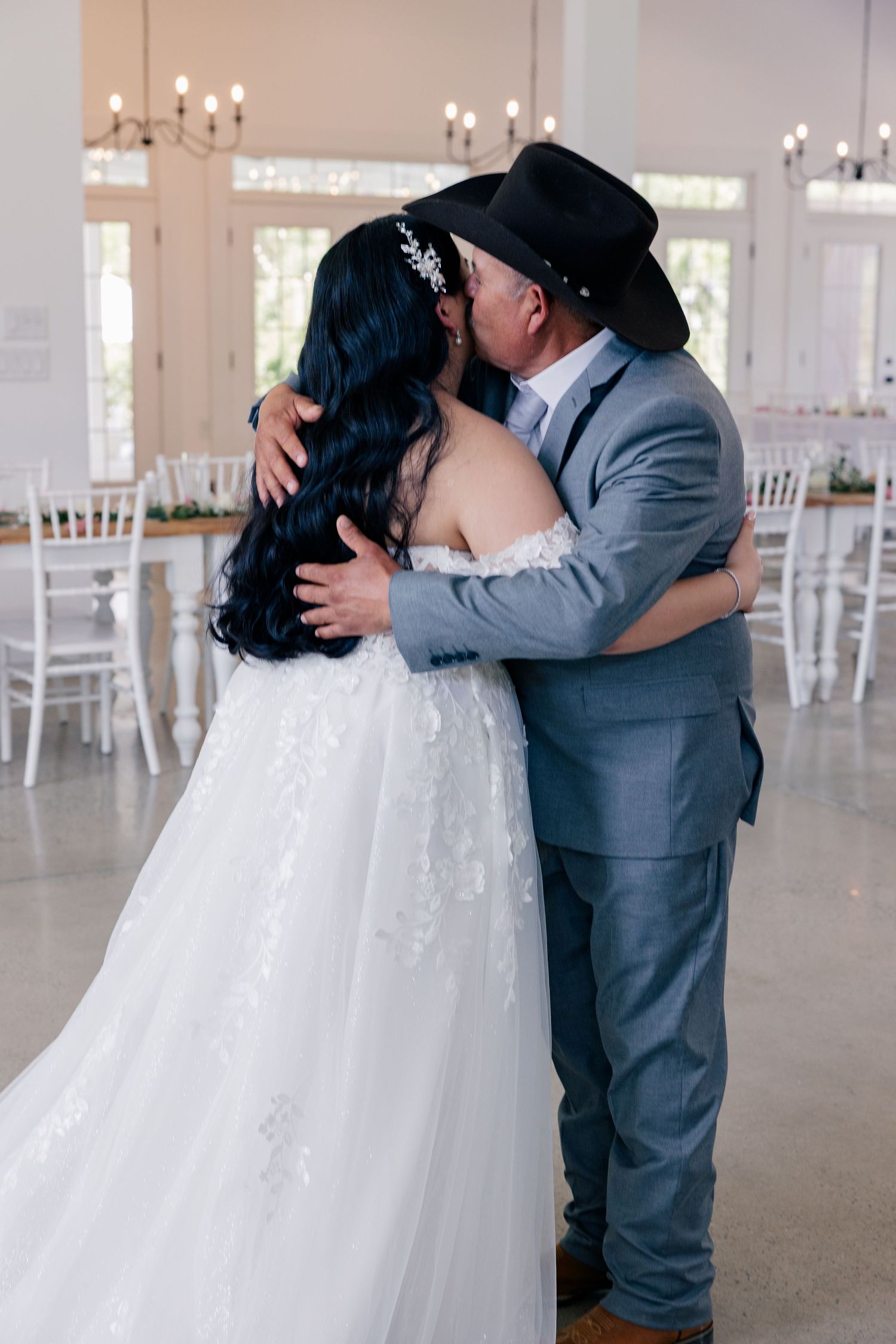 A series of intimate wedding moments showing a couple in formal attire embracing in an elegant white venue.