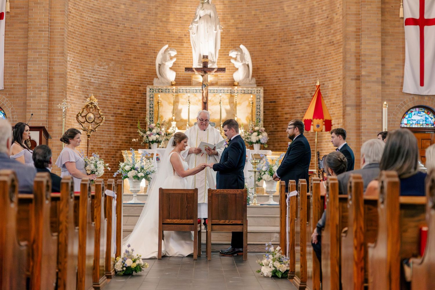 Bride and groom exchange vows at a beautiful church altar during a traditional wedding ceremony.
