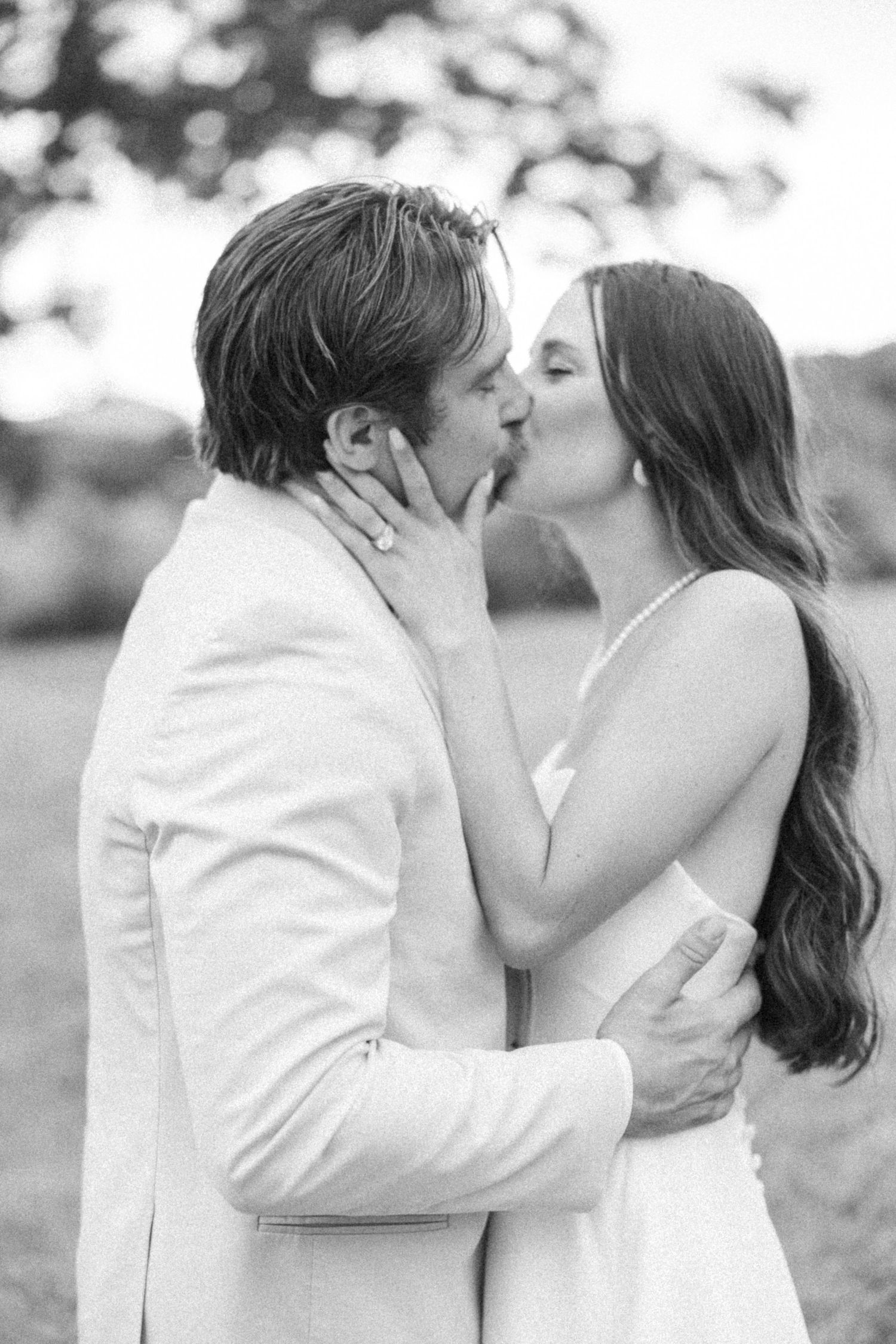 Black and white romantic wedding portrait sequence showing tender moments in an outdoor setting.