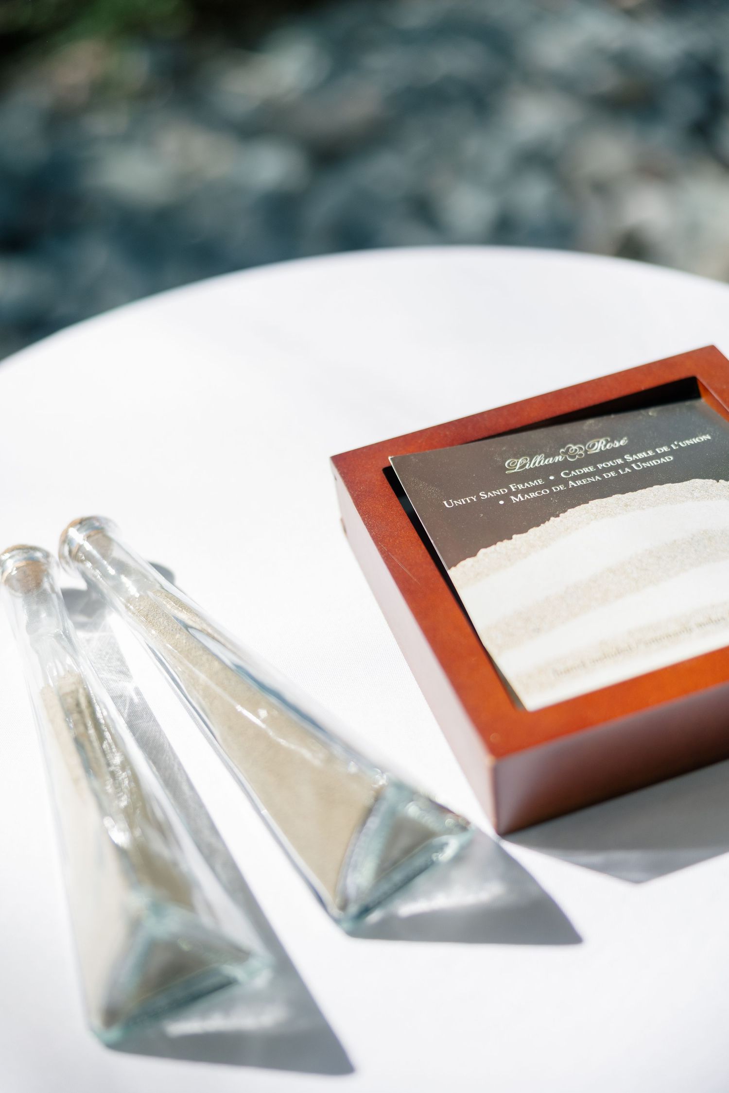 Crystal perfume bottles and elegant wedding stationery displayed on a white surface.
