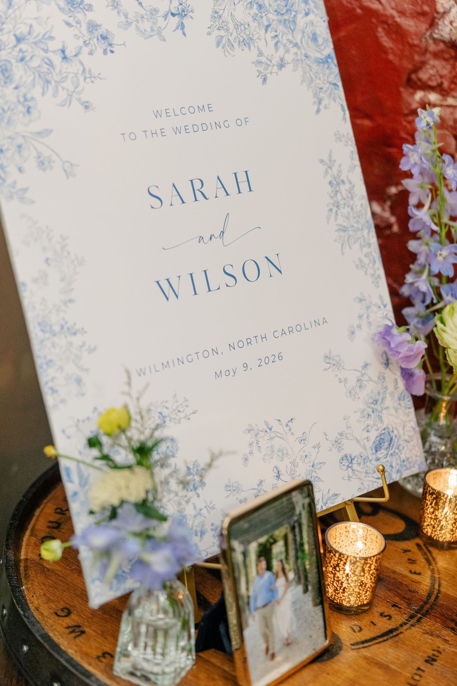 Blue toile floral welcome sign for Sarah and Wilson's wedding in Wilmington, North Carolina, May 9.