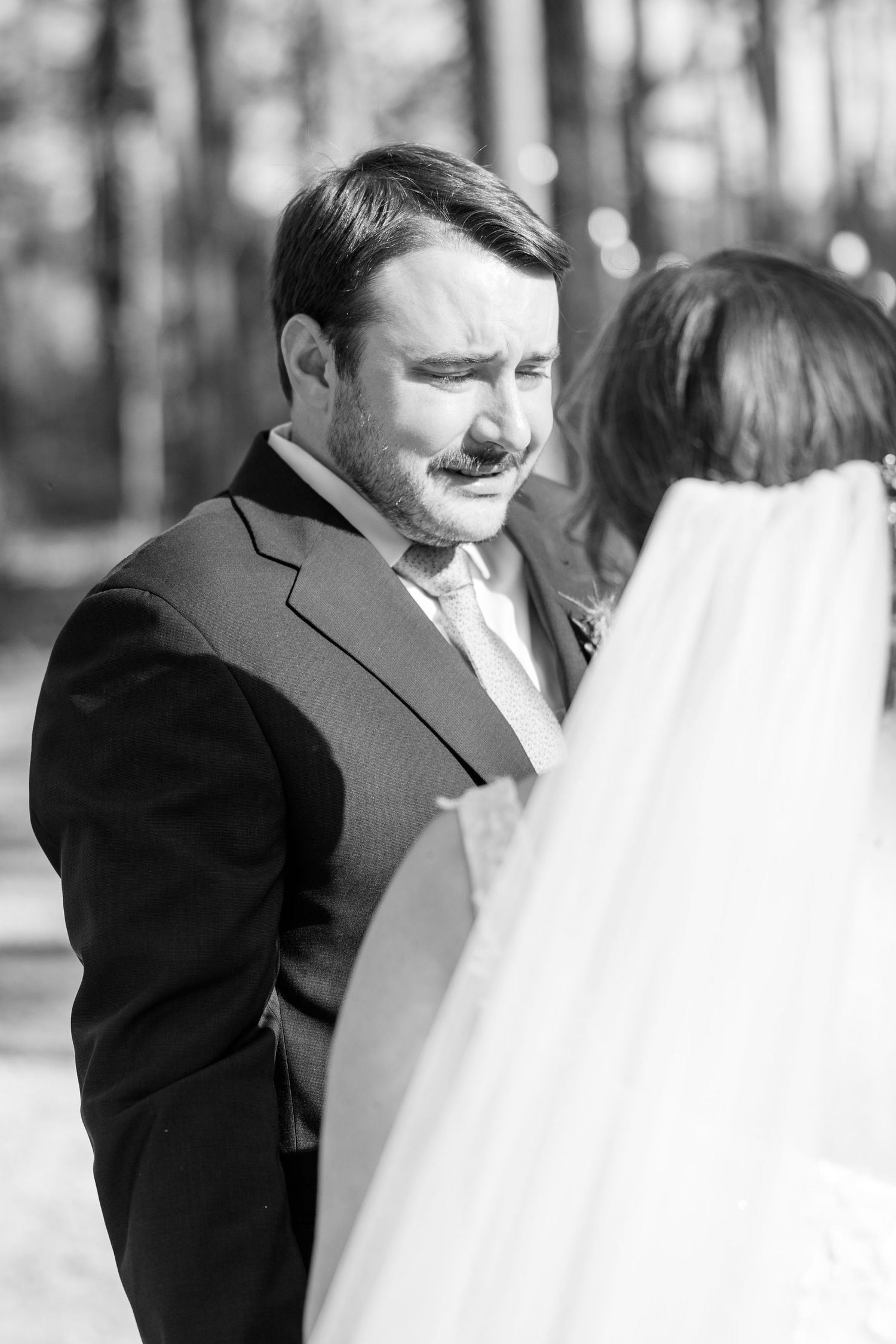 Wedding couple sharing an intimate black and white moment outdoors.