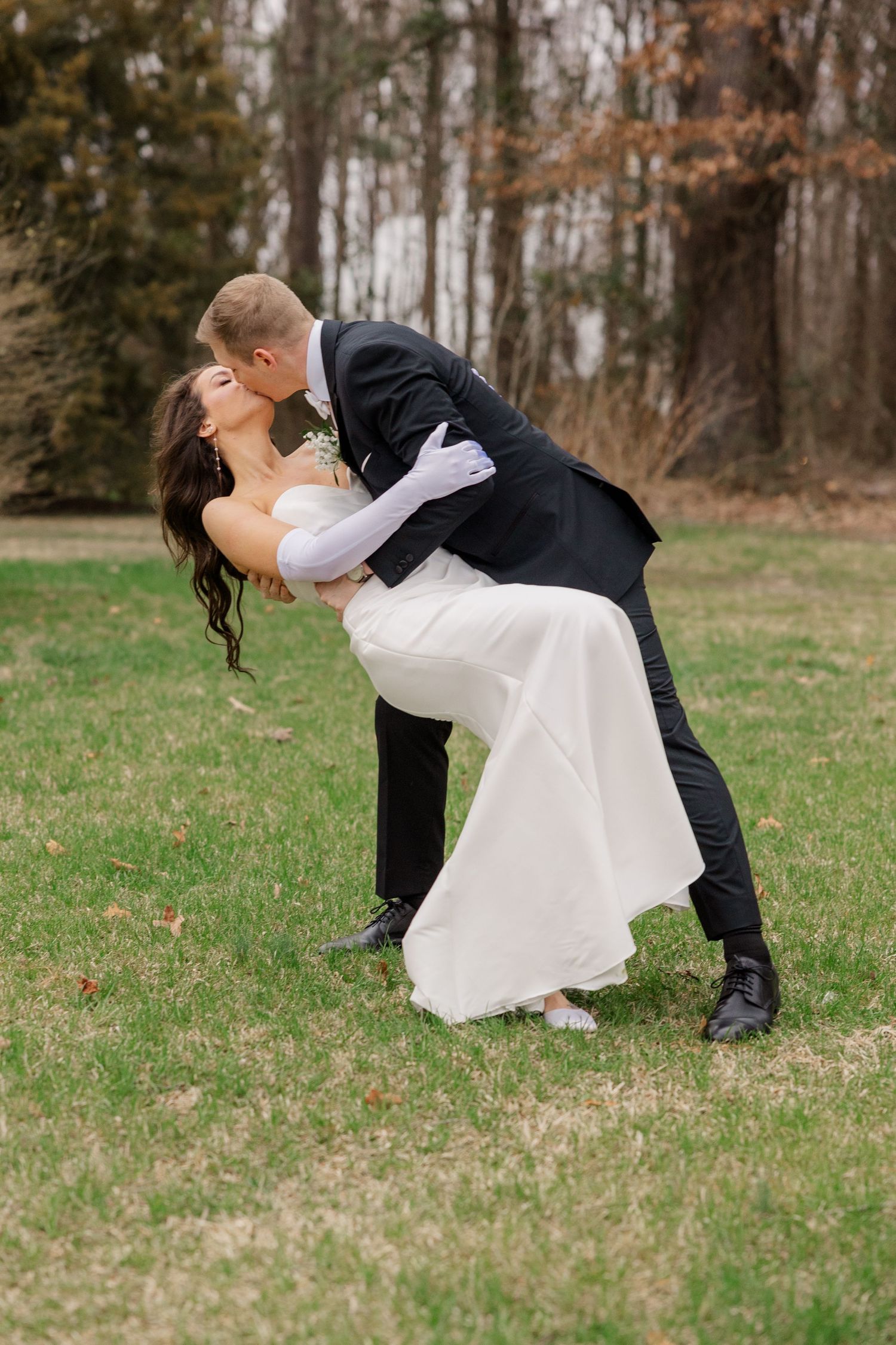 A sequence of romantic outdoor wedding portraits showing a couple in classic formal attire dipping in a grassy field.