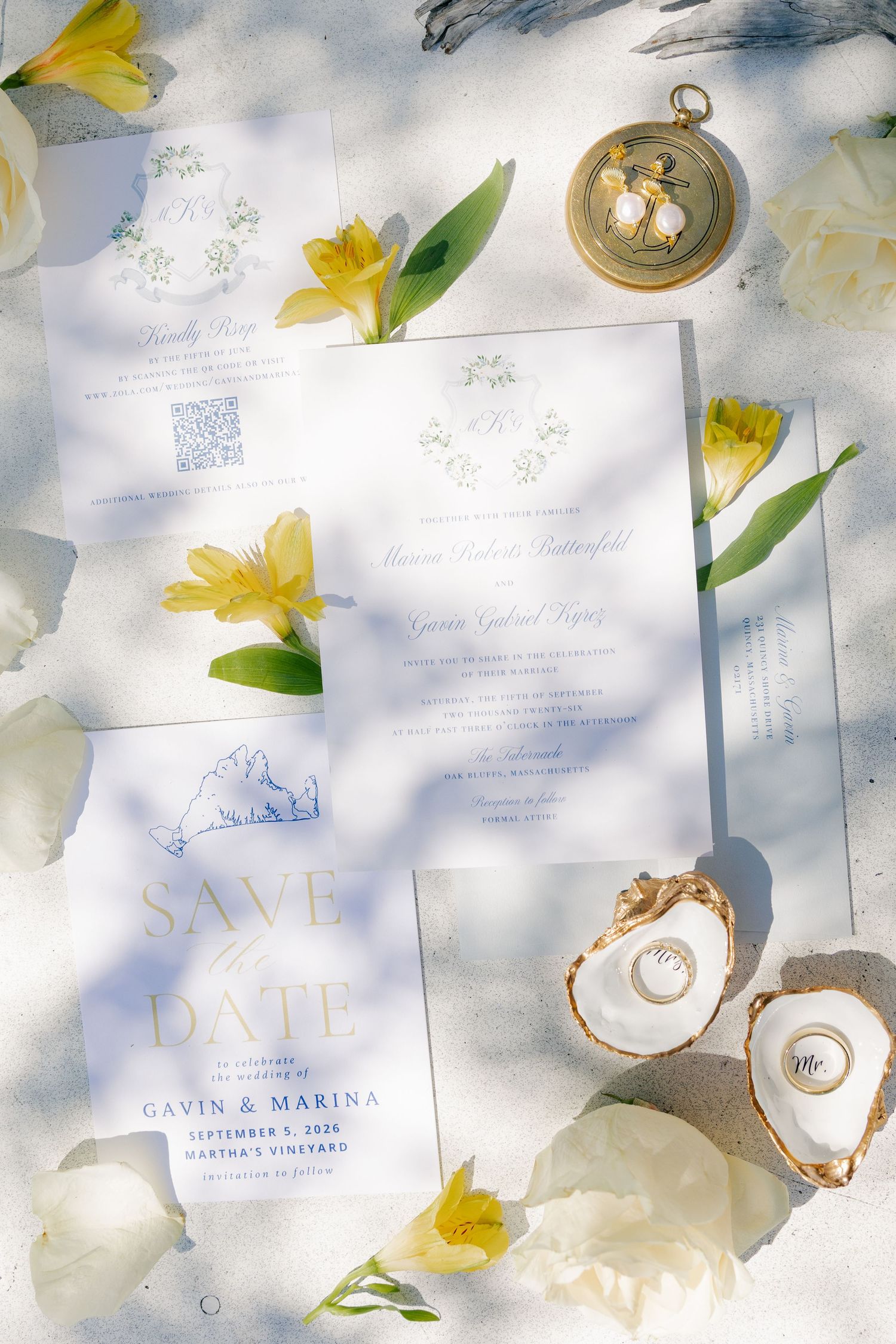 Wedding stationery flat lay with save the date, invitations, yellow flowers, rings in oyster shells.