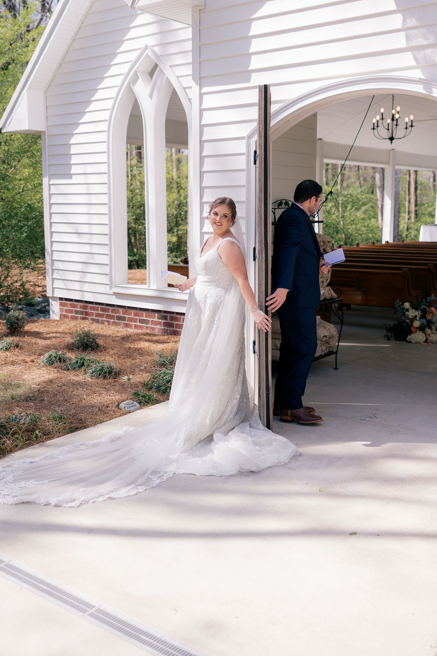 White wedding chapel exterior with Gothic-style arched windows and covered walkway.