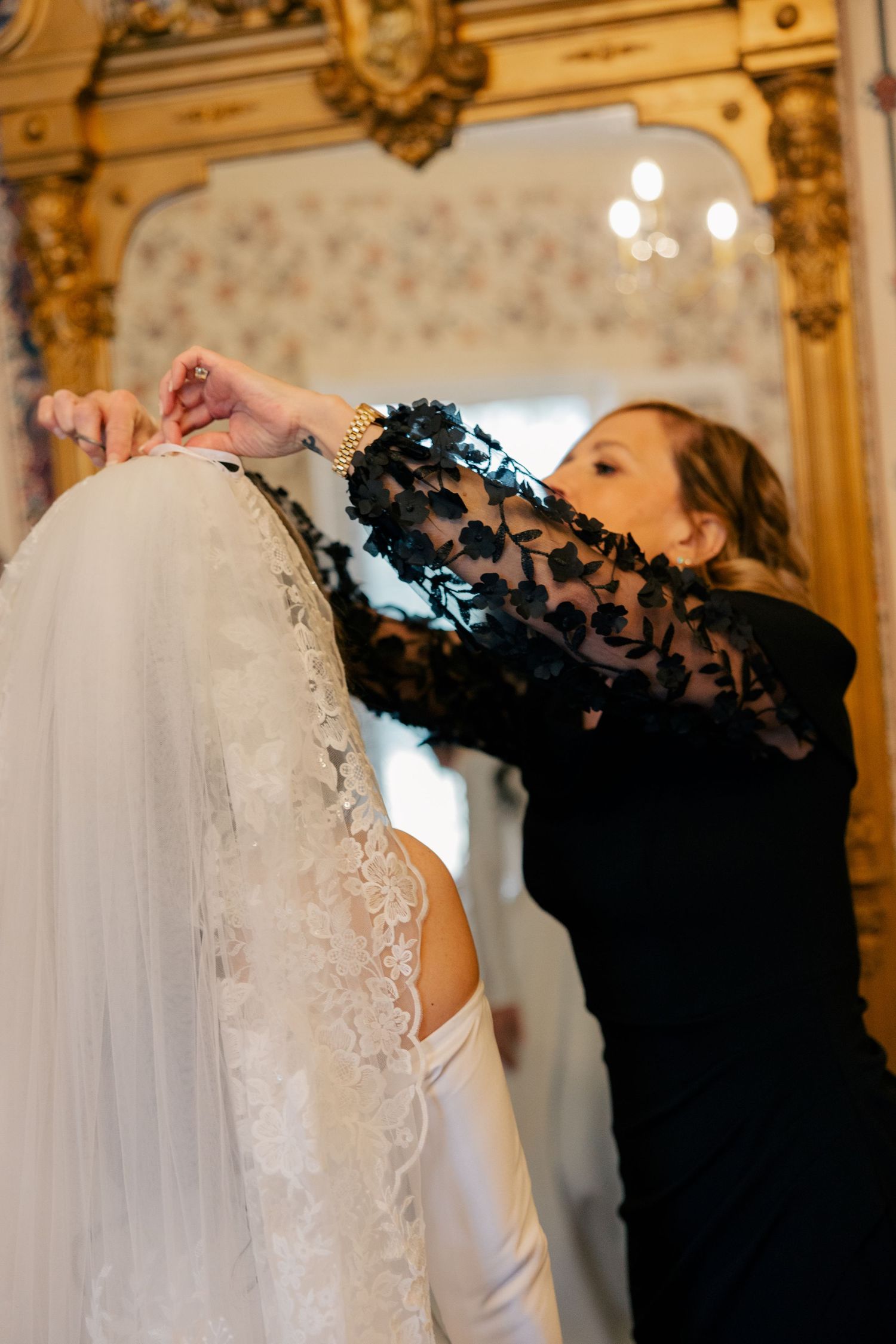 Wedding dress preparation scene in an ornate gold-trimmed room.
