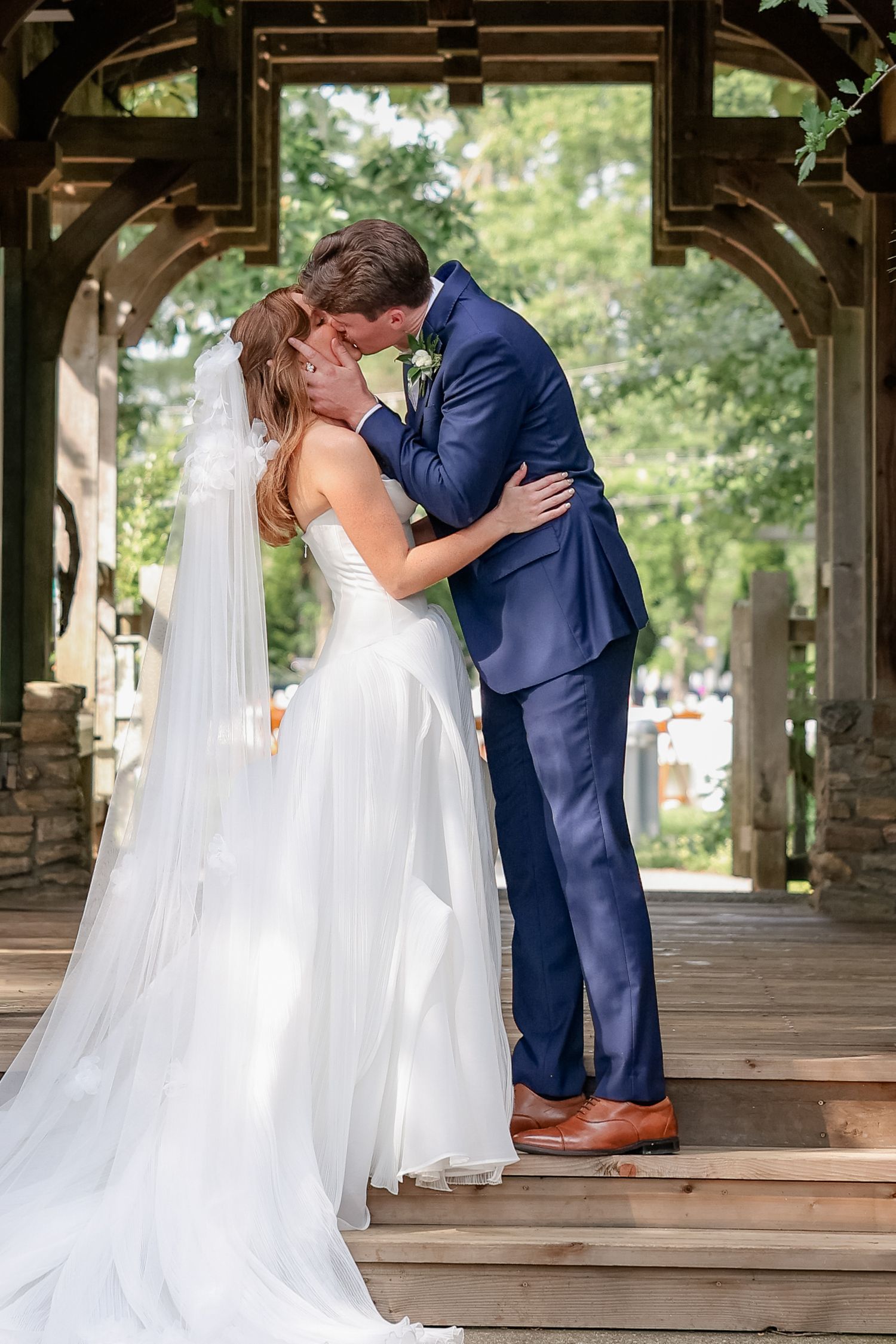 A romantic first look moment between newlyweds under a covered walkway.