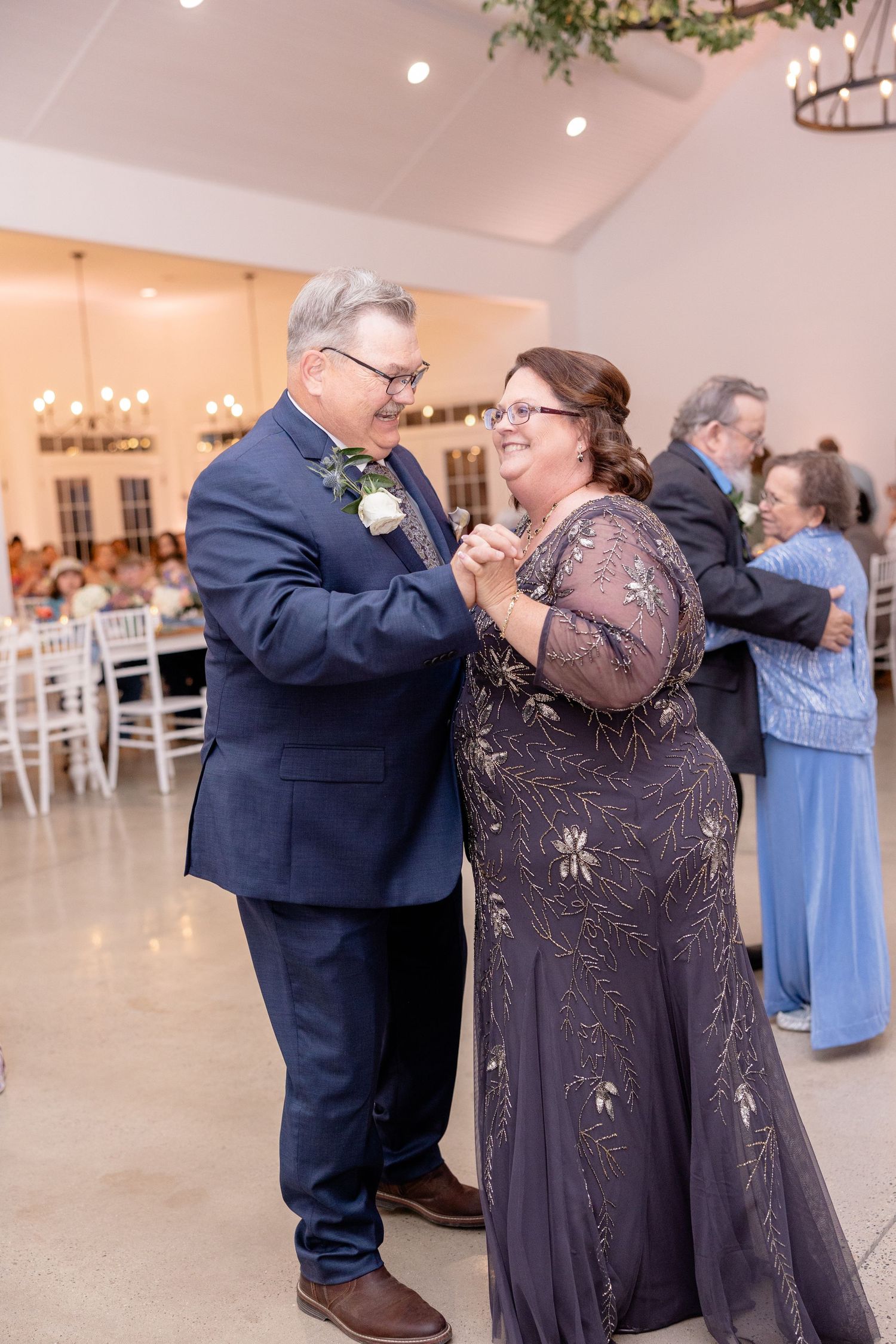Wedding reception dance featuring couples enjoying a special moment on the dance floor.