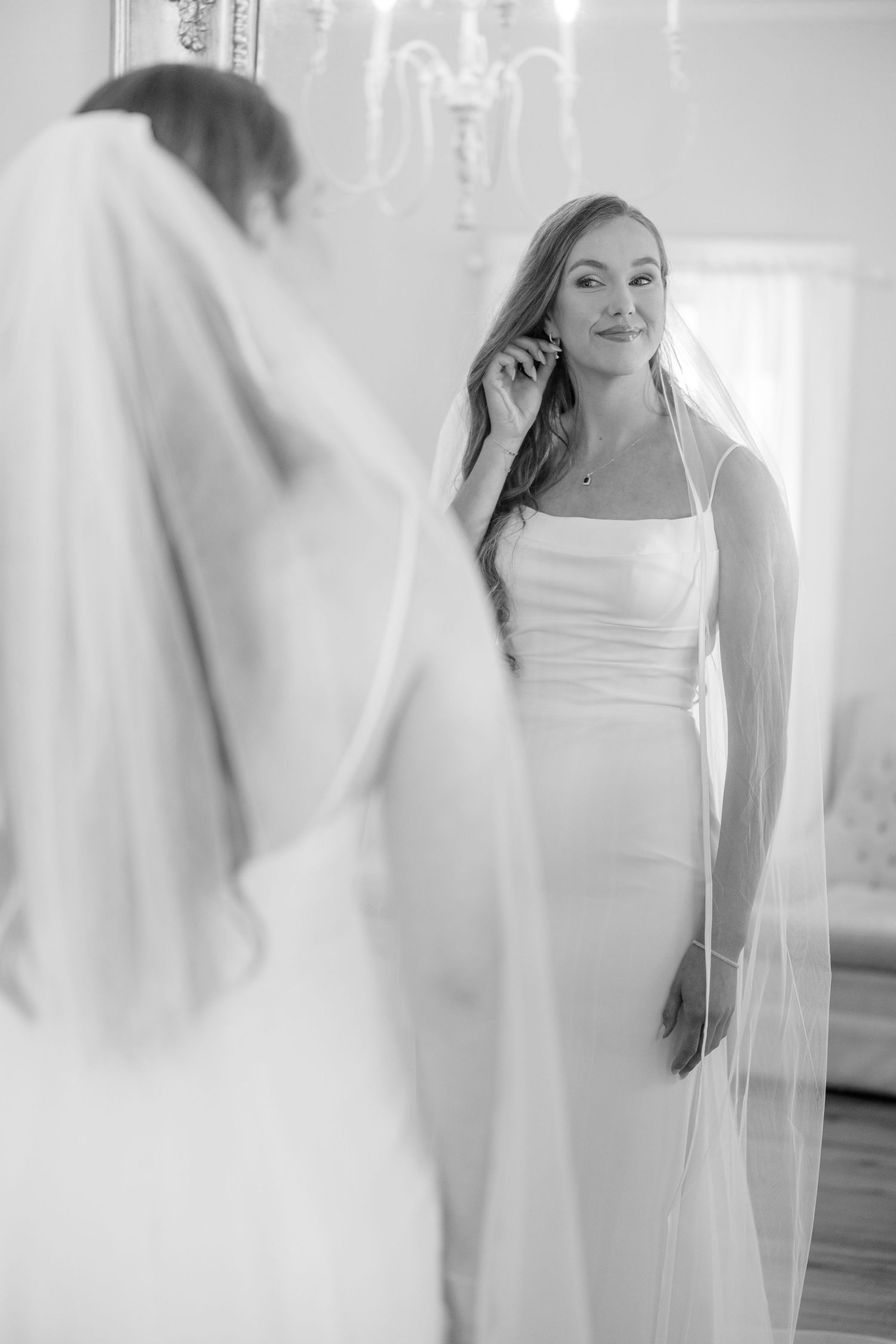Ethereal bridal portraits in a bright white room with flowing fabric and soft natural light.