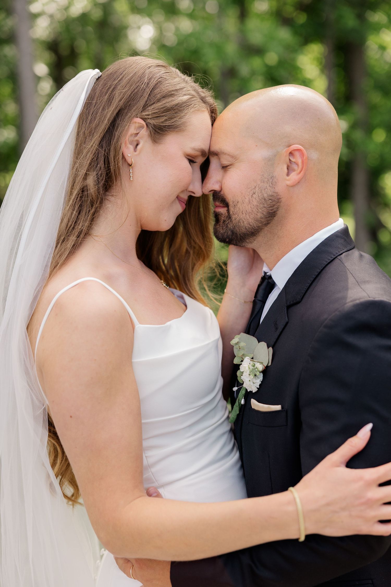 Romantic close-up of couple sharing intimate moment outdoors in natural setting.