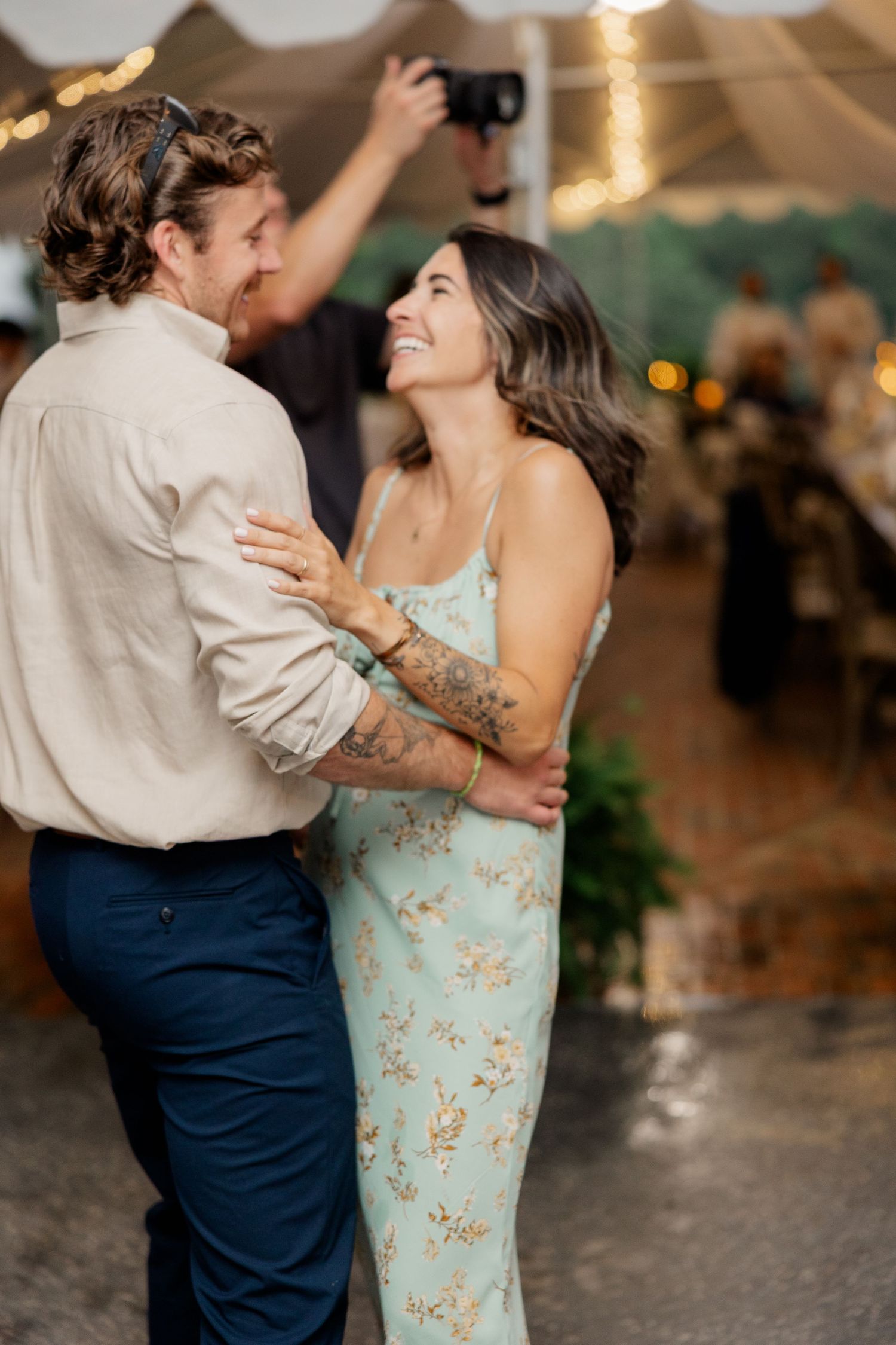 Couples slow dancing together at a romantic wedding reception under soft lighting.