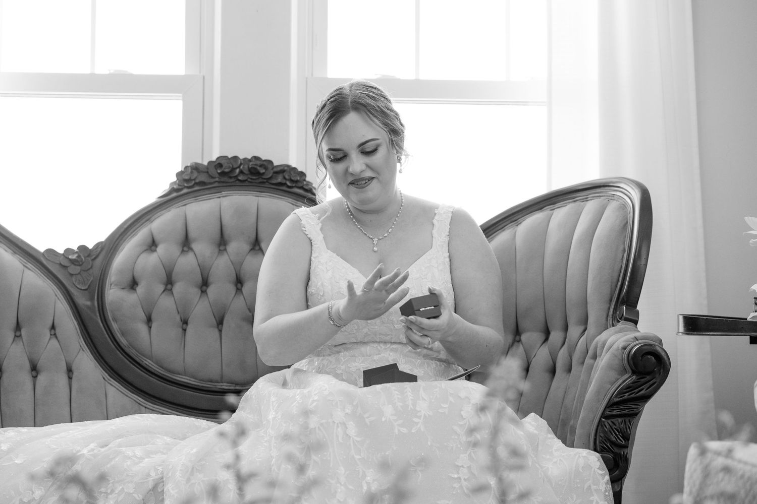 Elegant gray tufted sofa seating arrangement in bright white room setting.